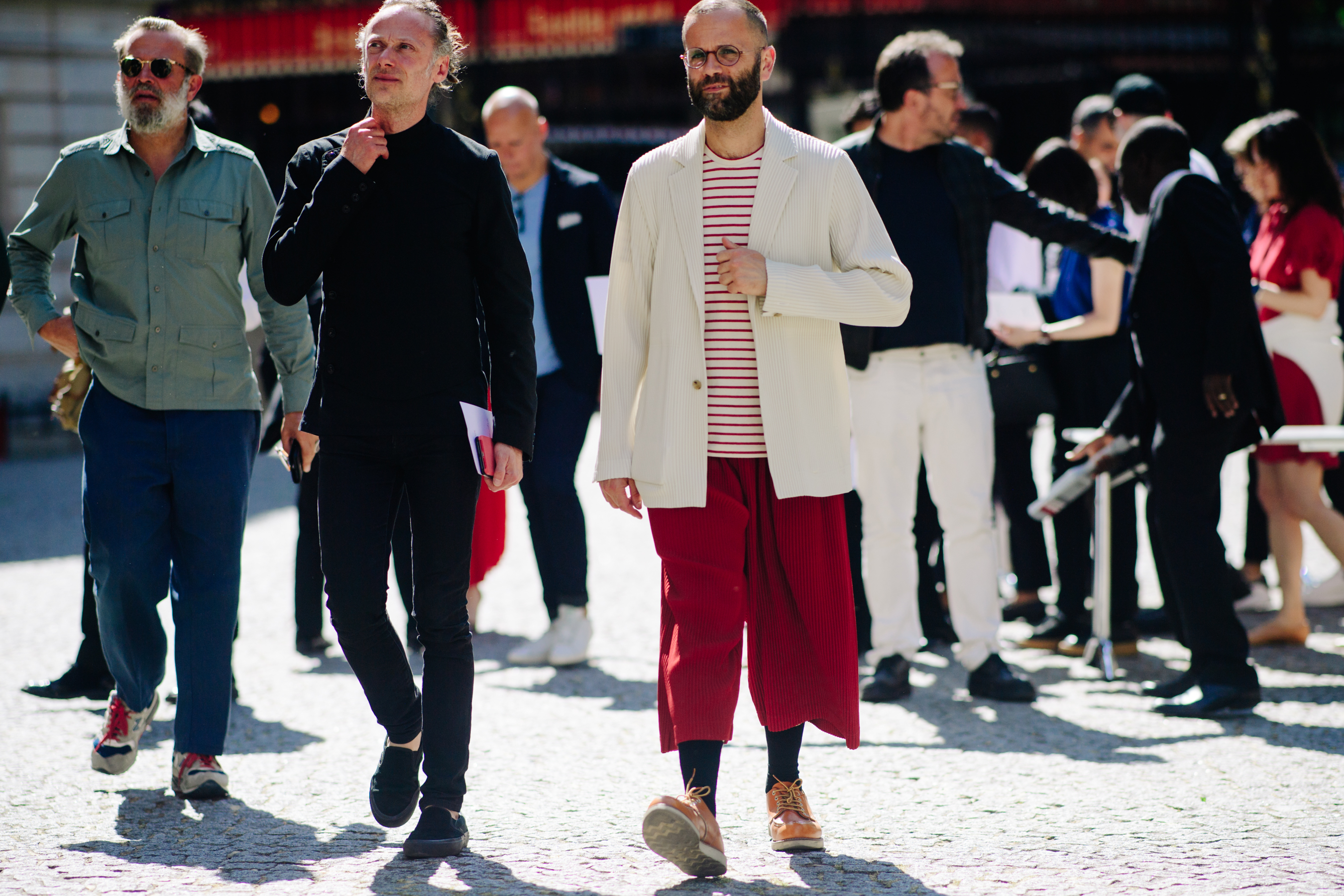 Two men wearing contrasting outfits