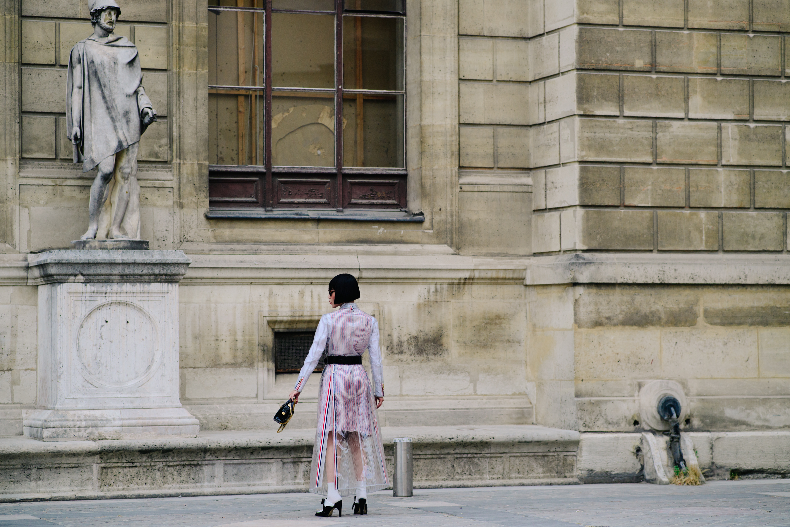 Woman wearing a Thom Browne coat