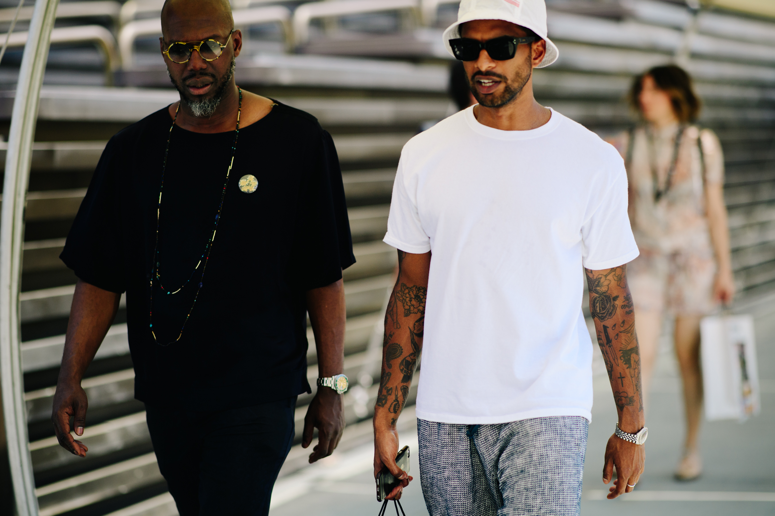 Two men wearing contrasting outfits