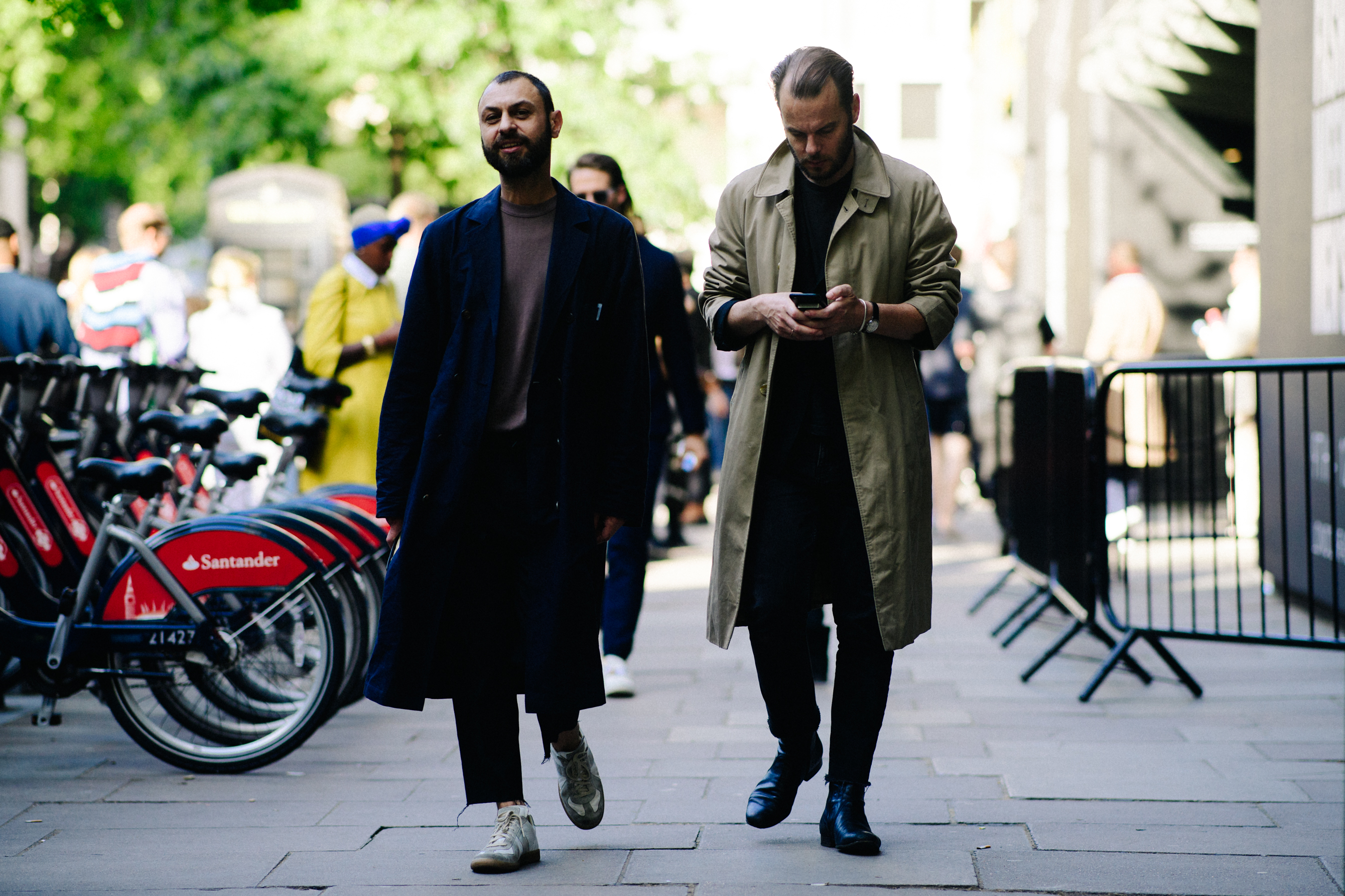 Two men wearing long coats