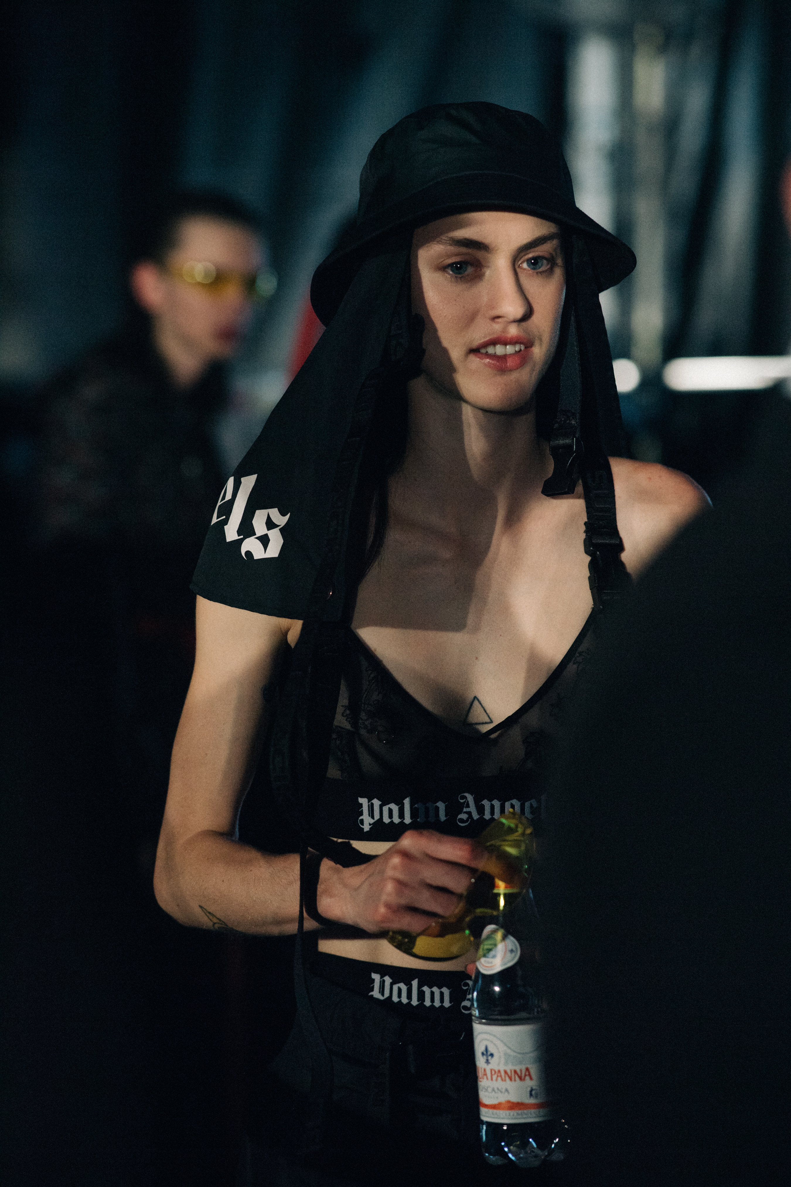 Model carrying a bottle of water