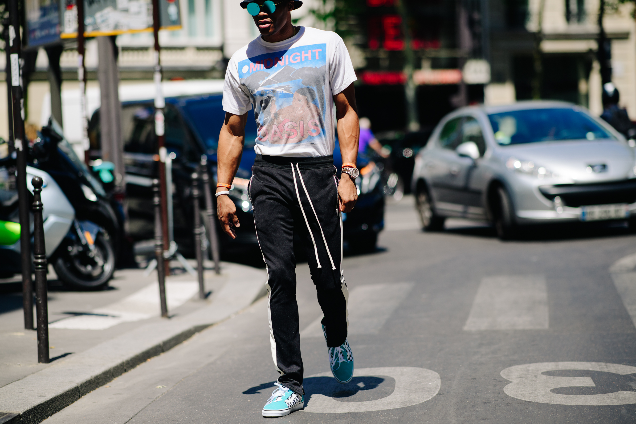 Man wearing blue Vans plimsols