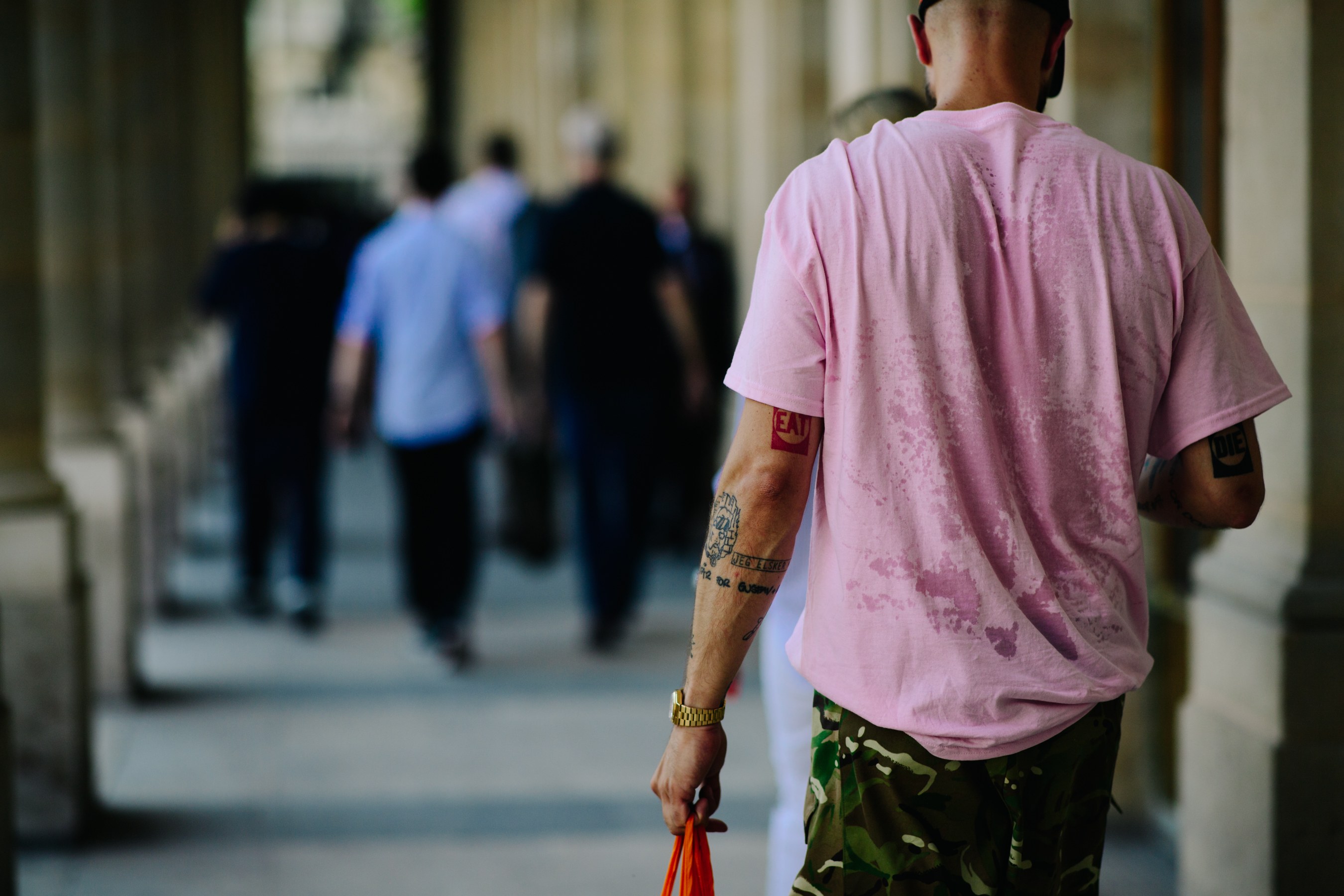 Man wearing a pink t-shirt