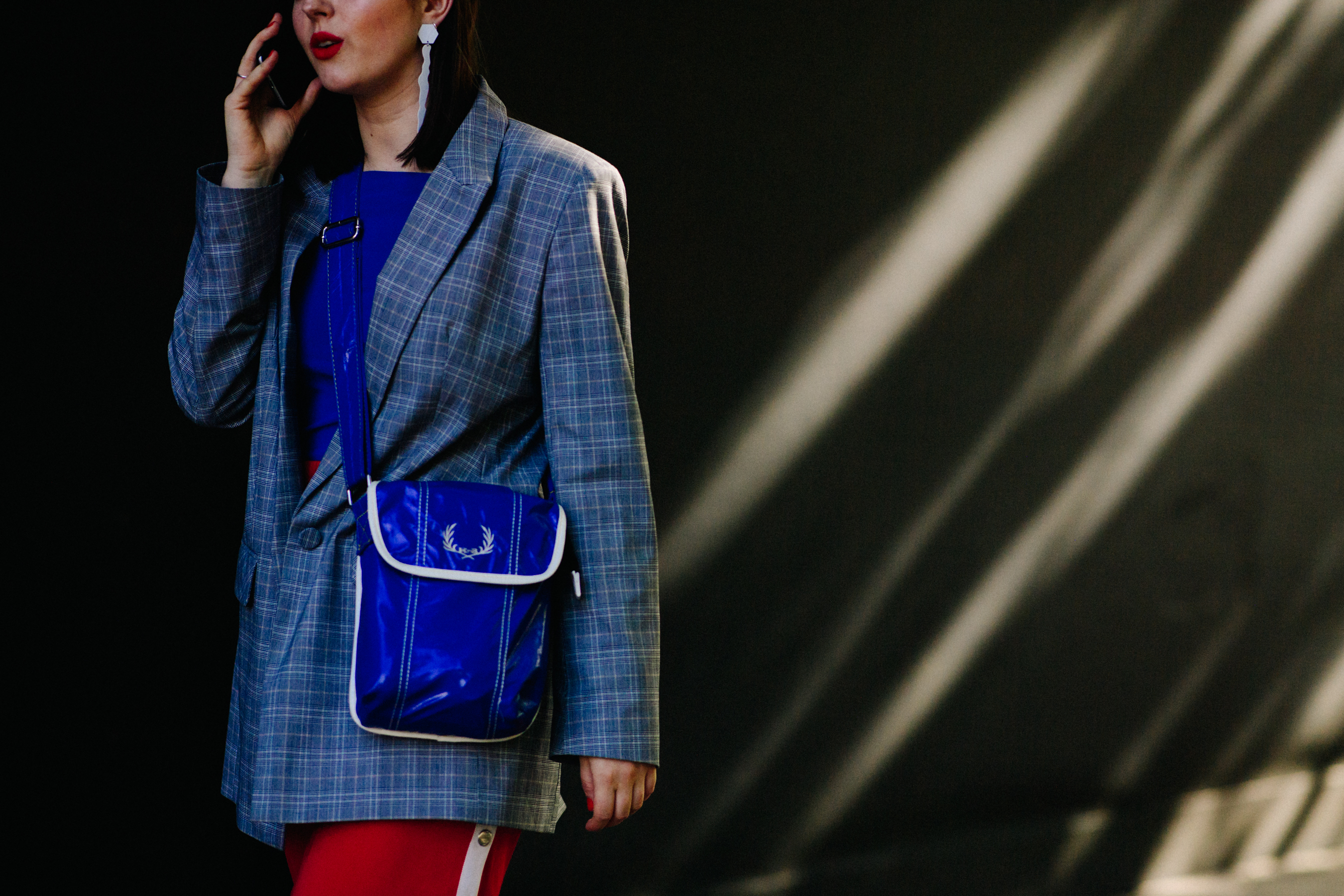 Woman wearing Fred Perry bag