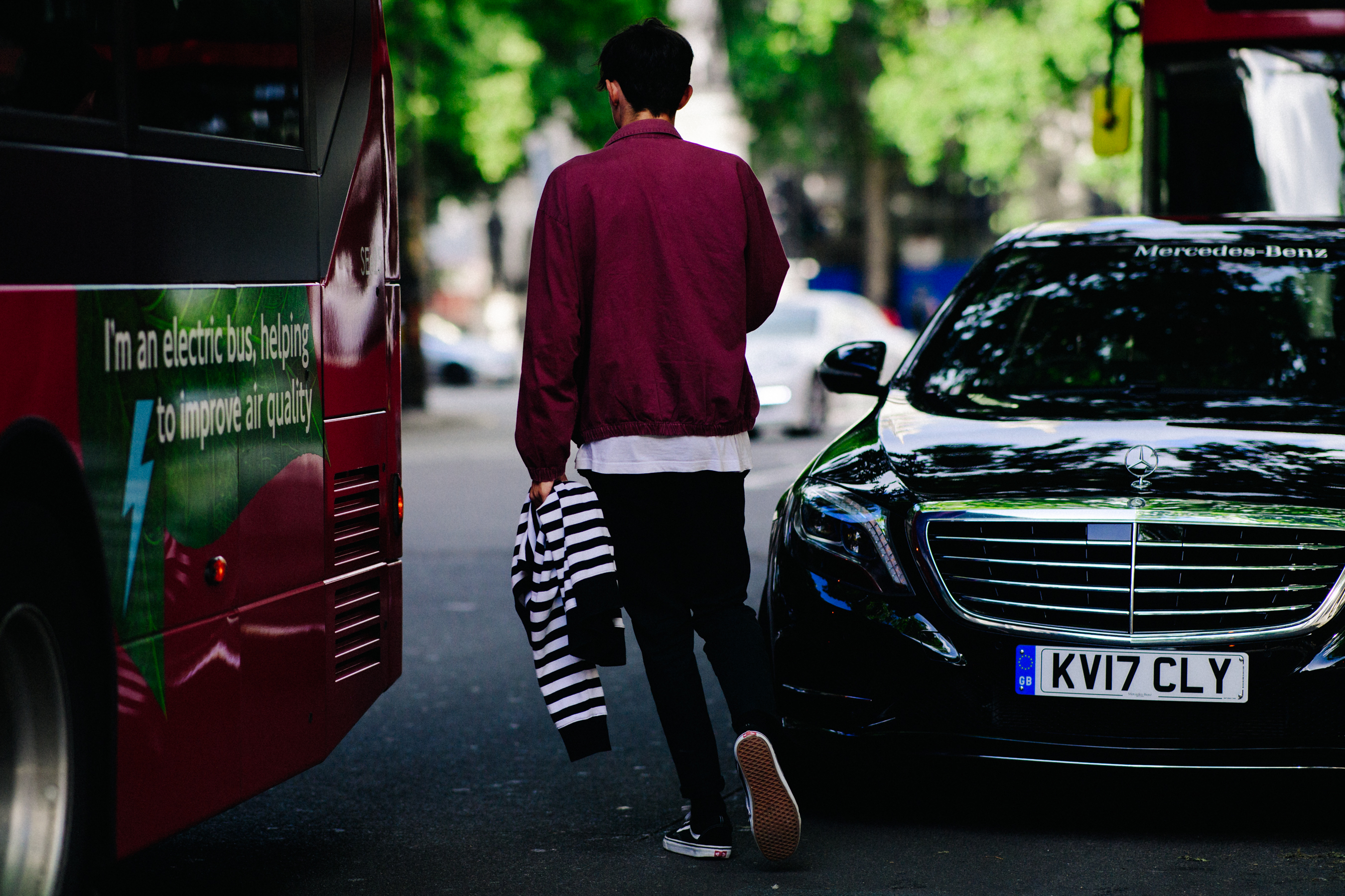 Man wearing Vans and red bomber