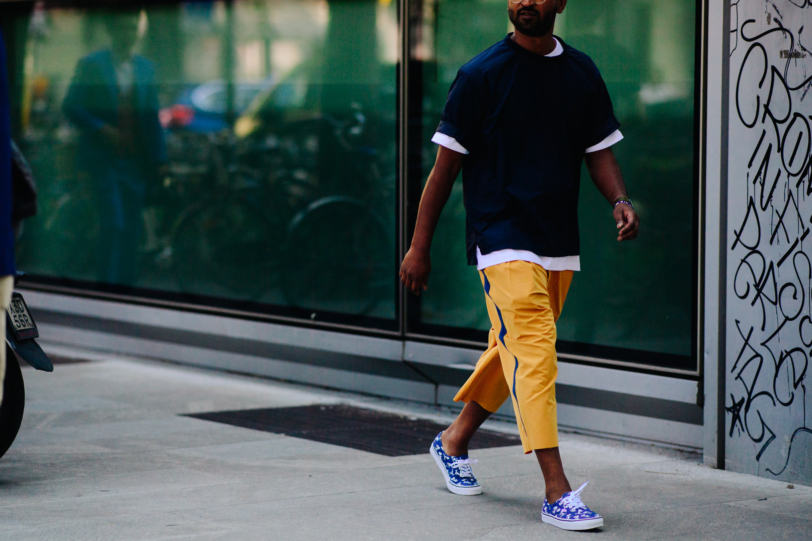 Man wearing printed blue Vans