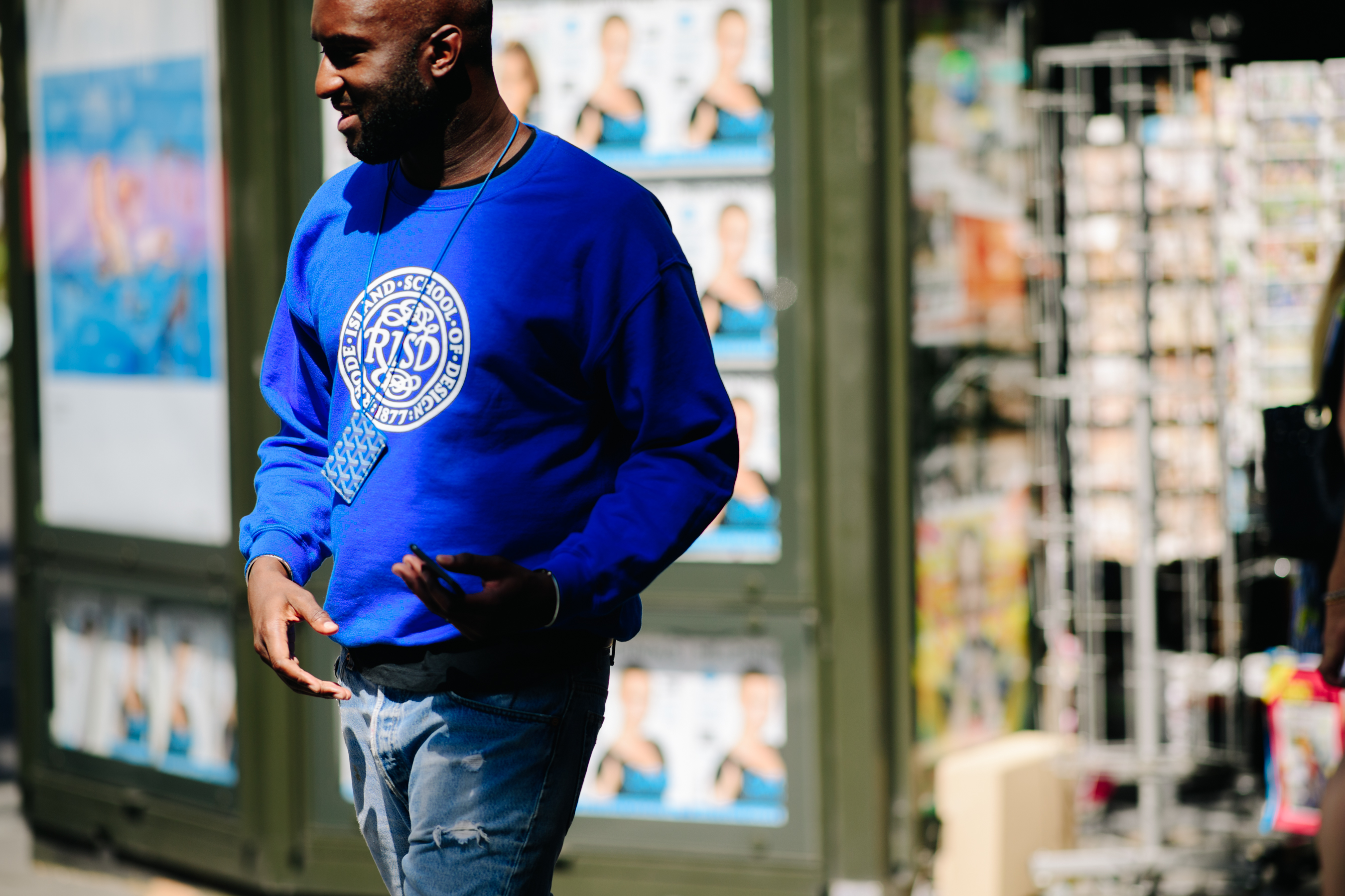 Fashion designer wearing a blue sweater
