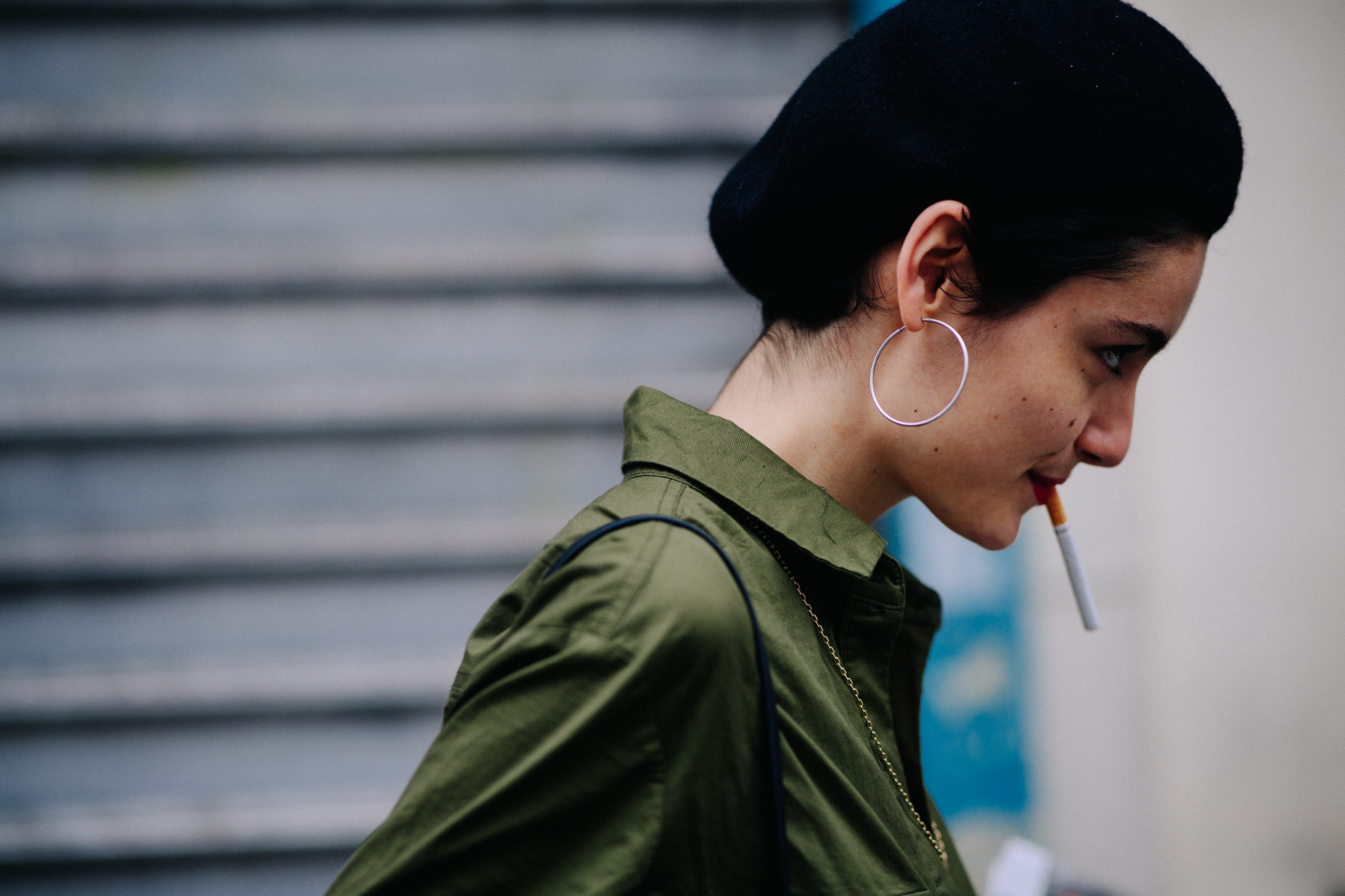 Woman wearing beret and green shirt