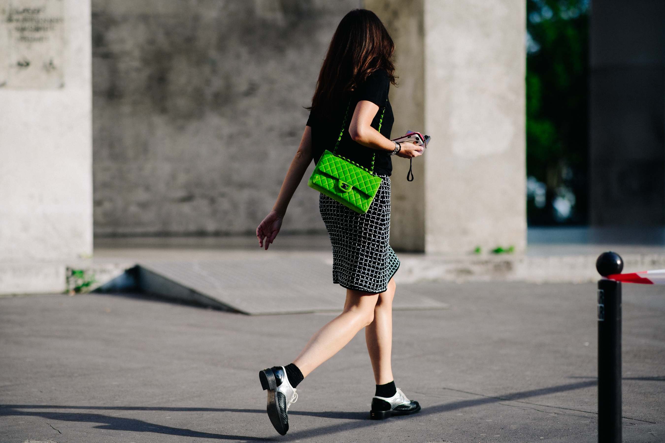 Woman wearing green Chanel bag