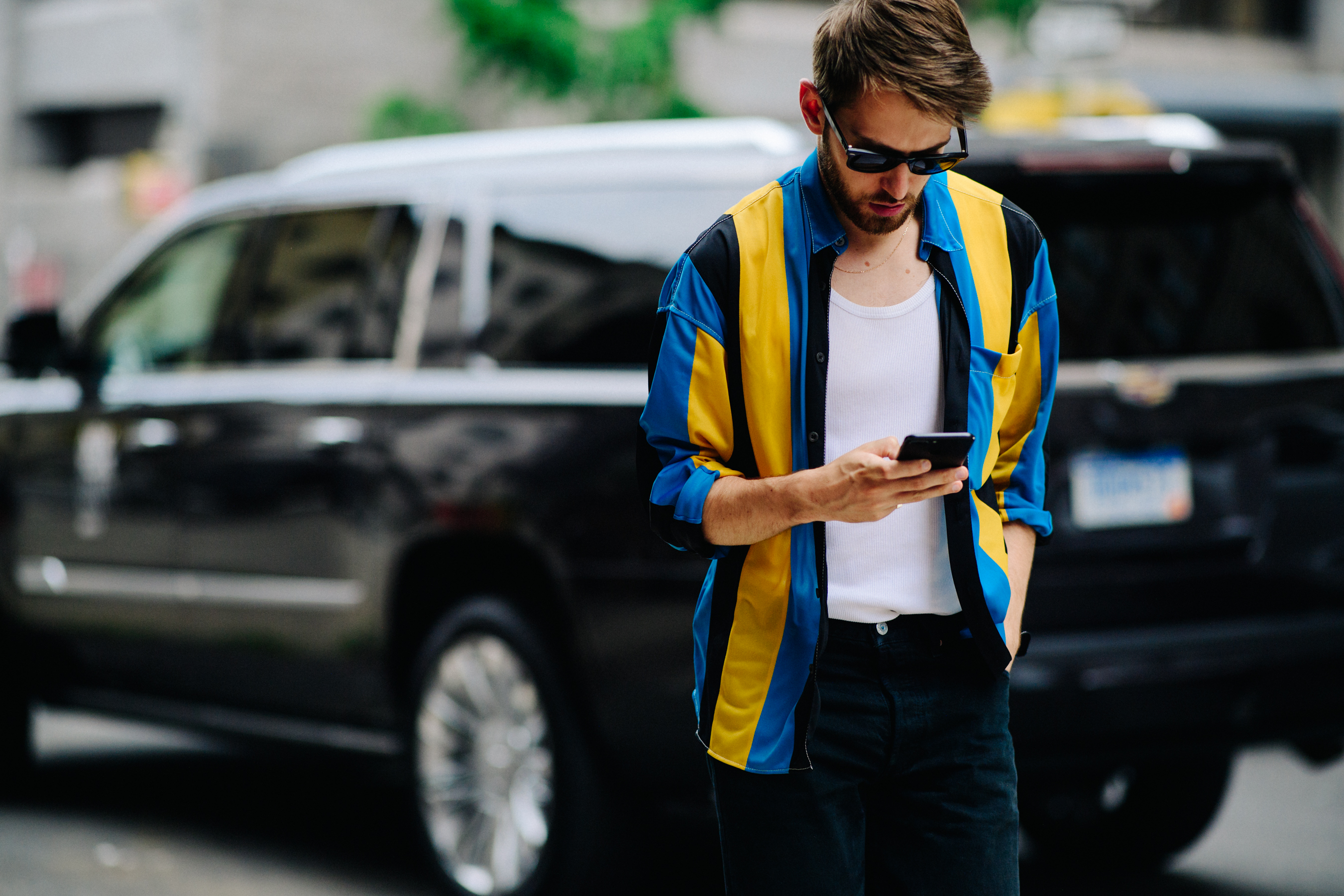Man wearing blue and yellow shirt