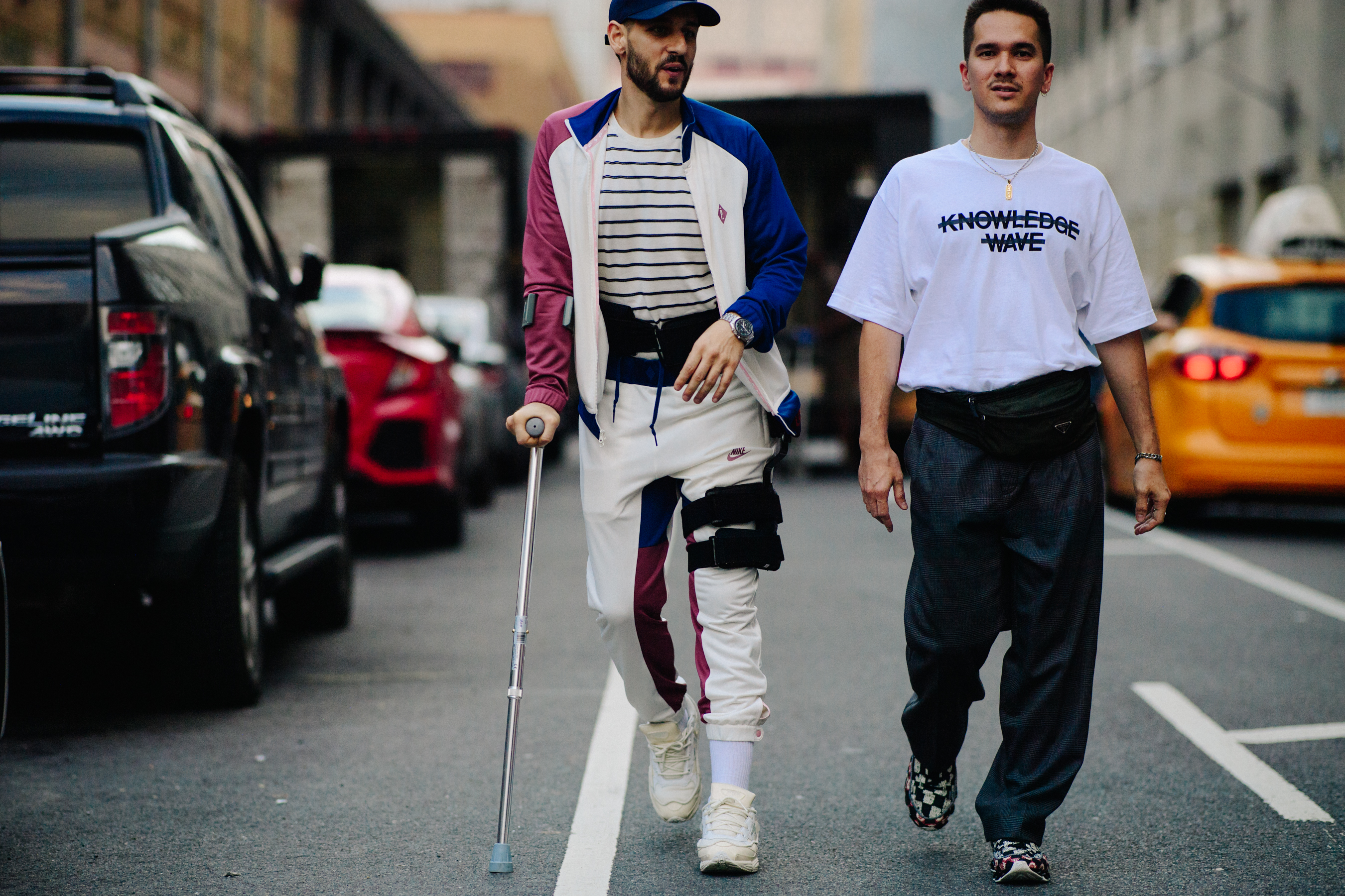 Man on crutches wearing Raf Simons sneakers