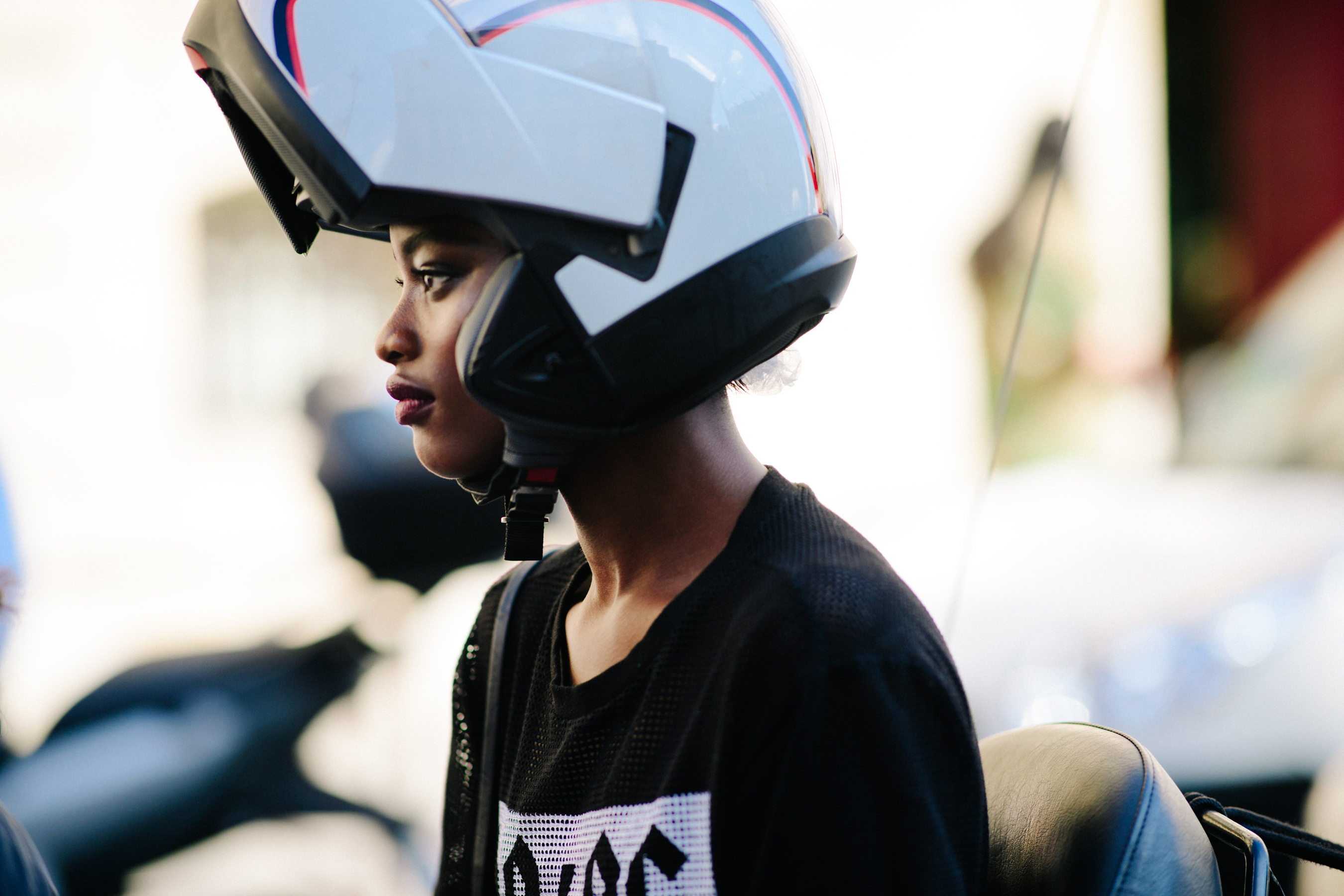 Model wearing scooter helmet after Ulyana Sergeenko