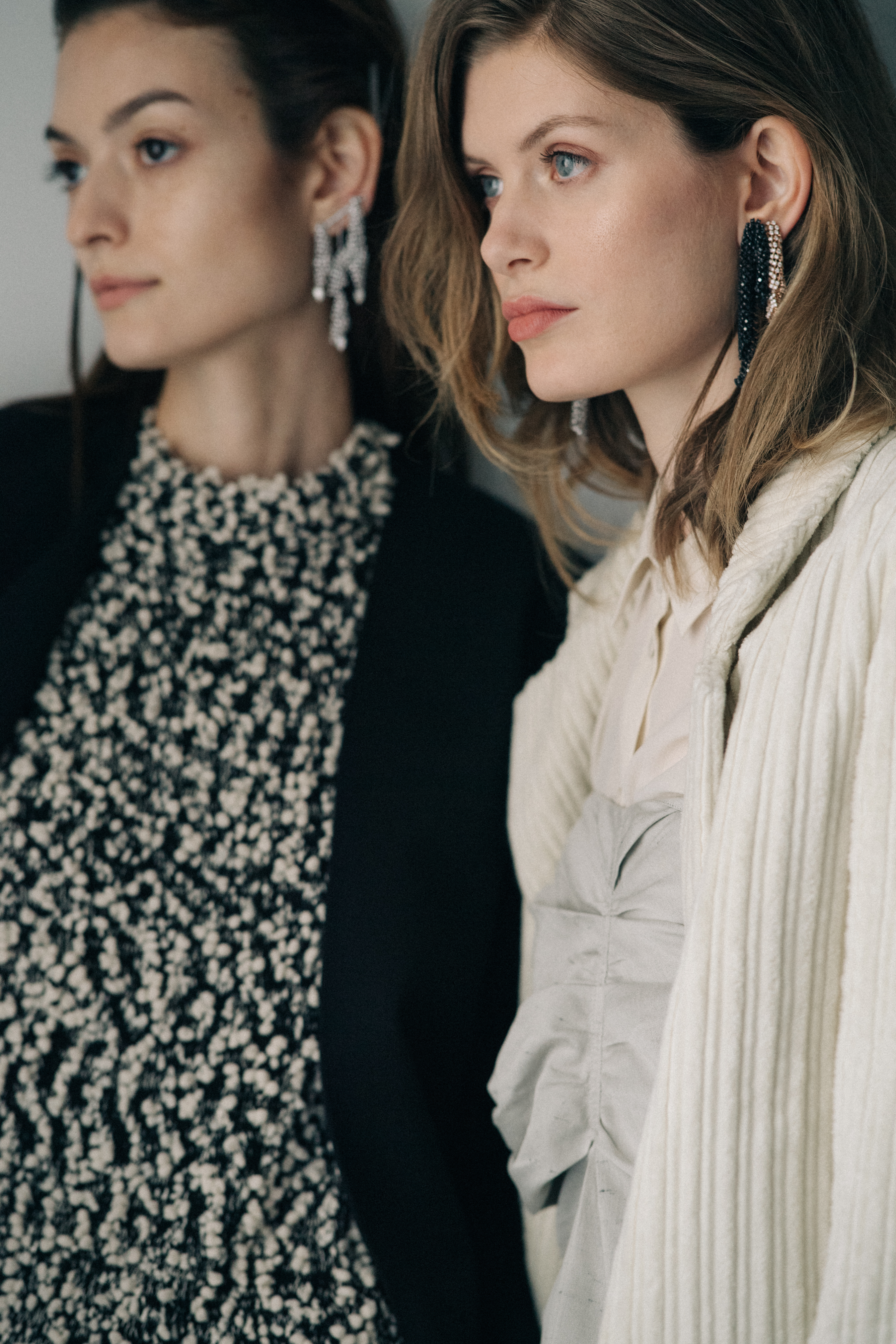 Model wearing earrings with stones