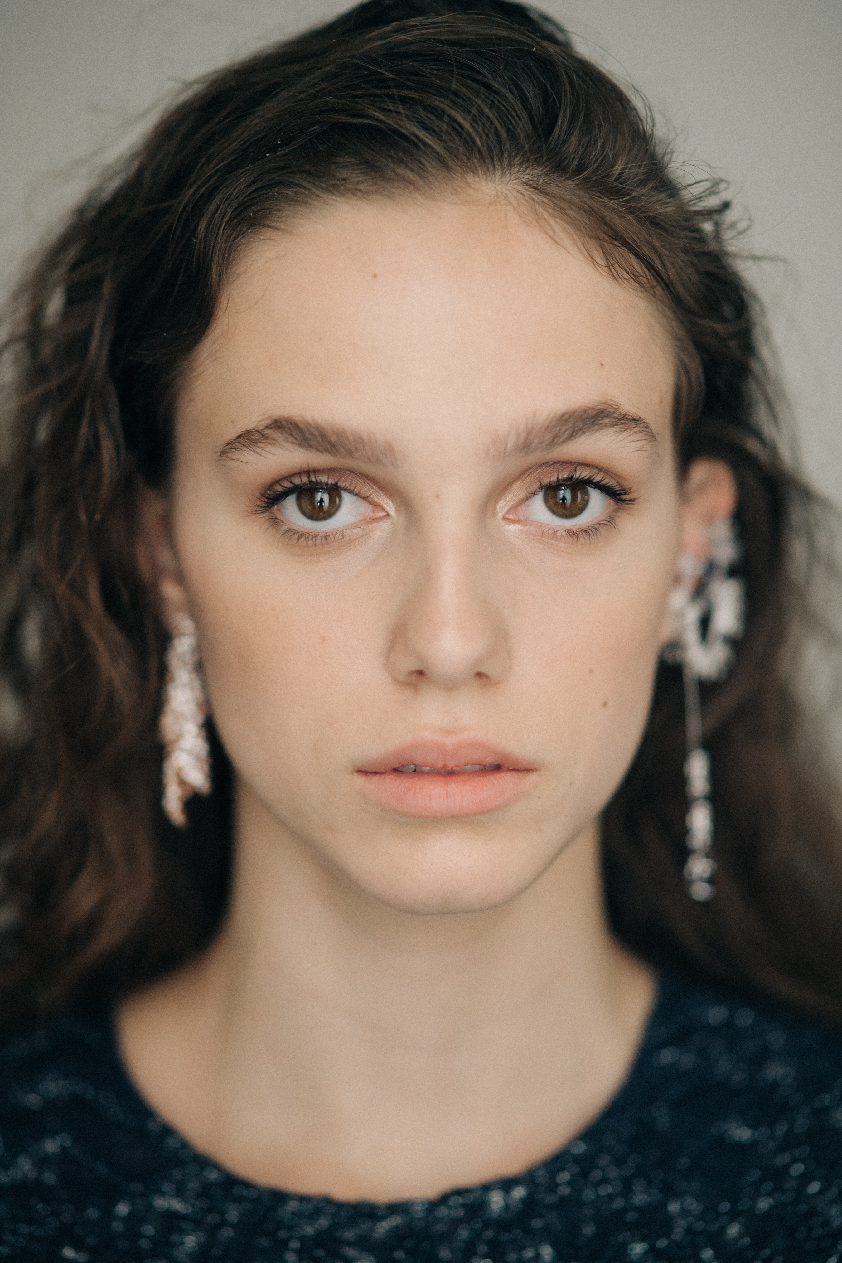 Model wearing earrings with stones