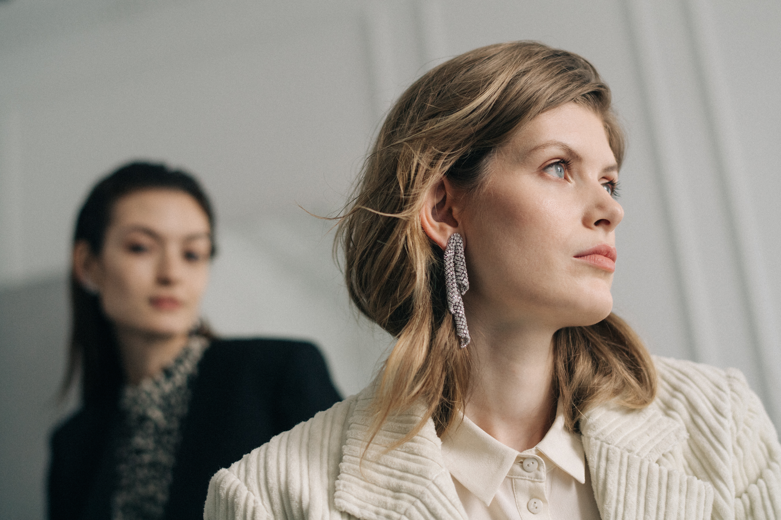 Model wearing earrings with stones