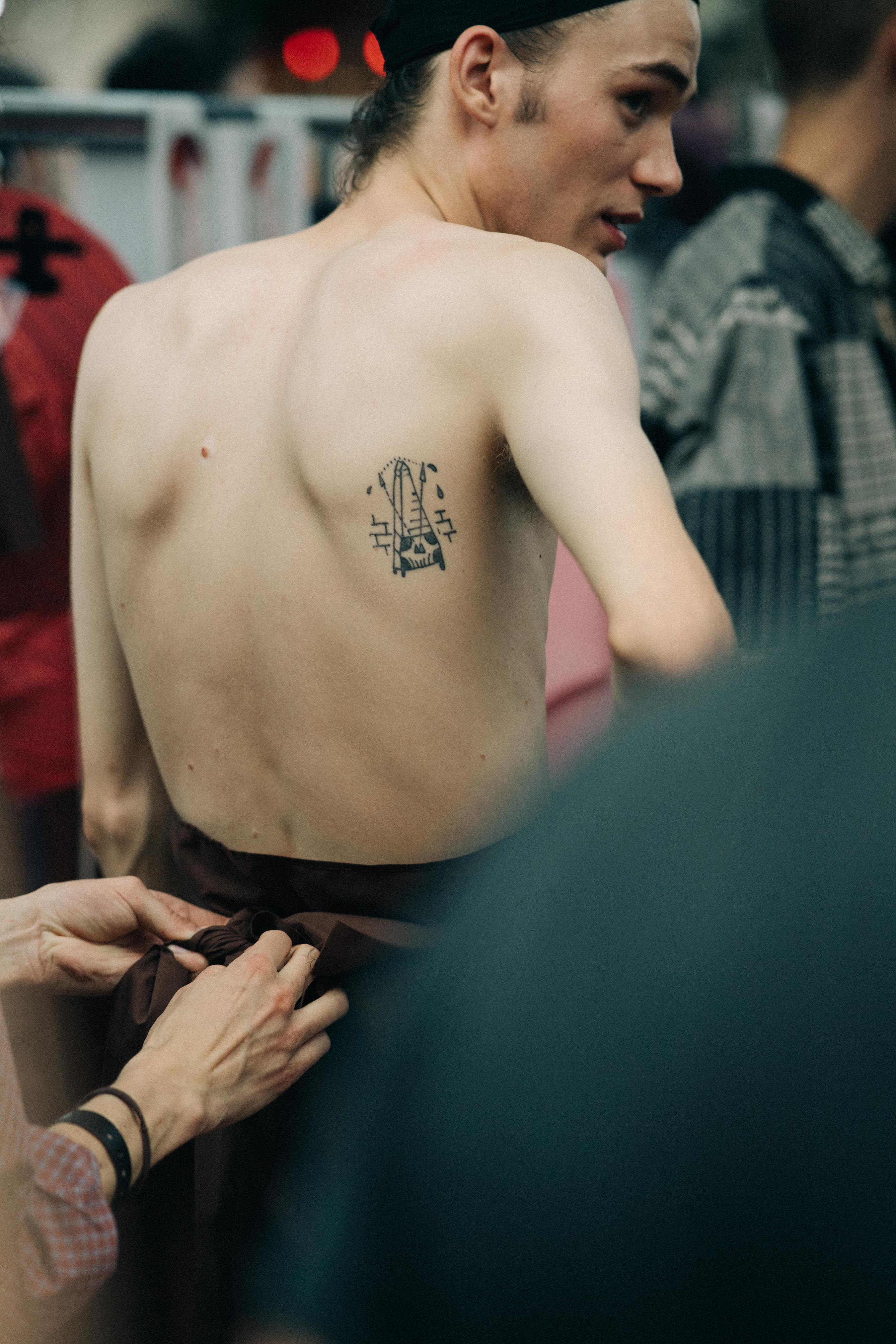 Male model getting dressed before a show