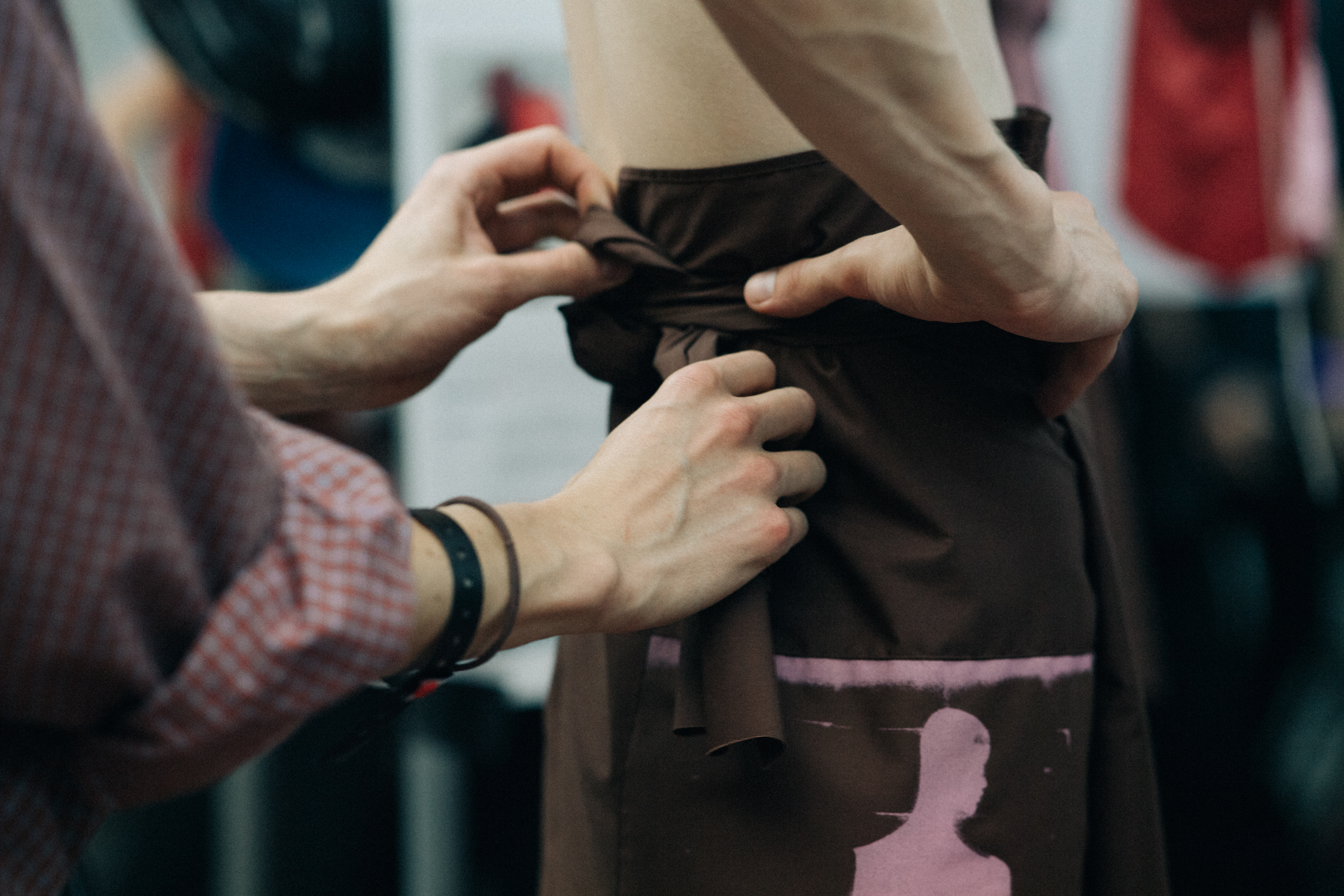 Male model getting dressed before a show