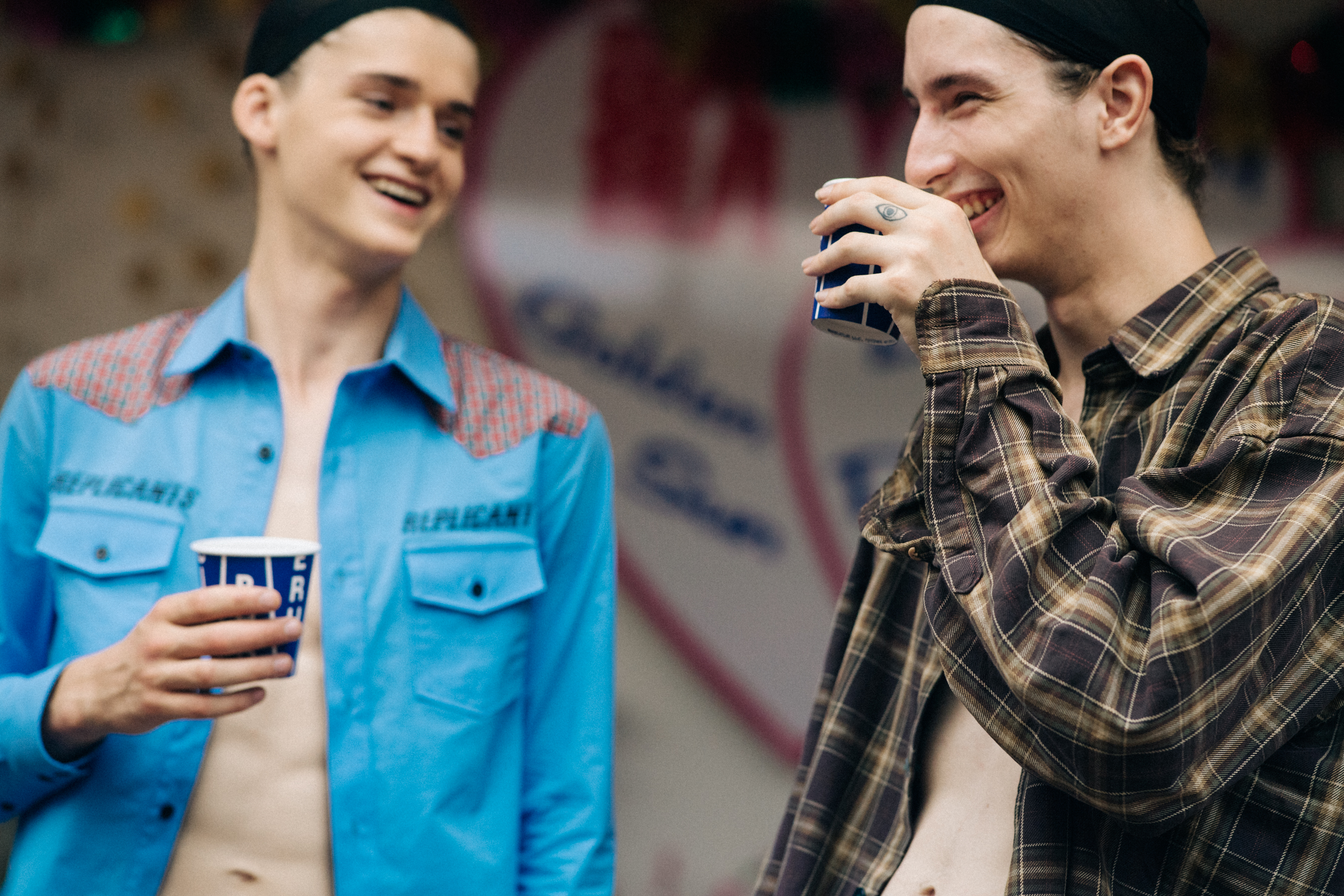 Two male models drinking before a show