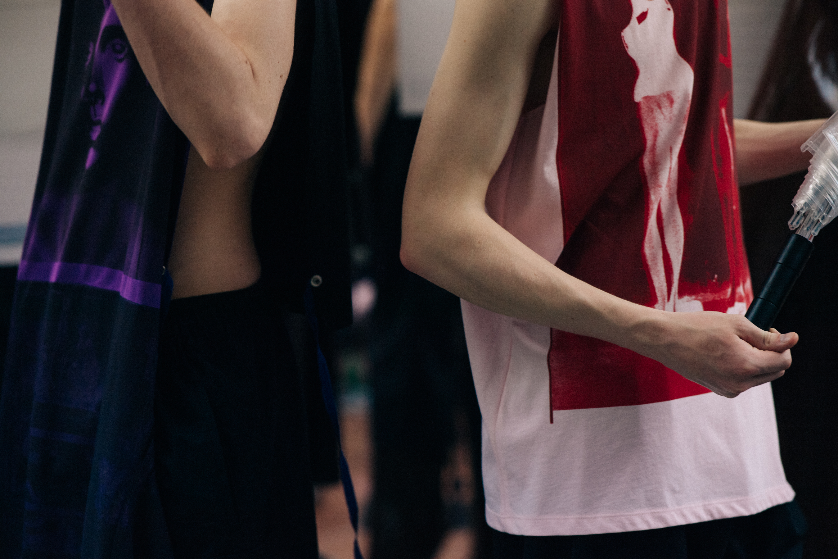 Two male models dressed before a show