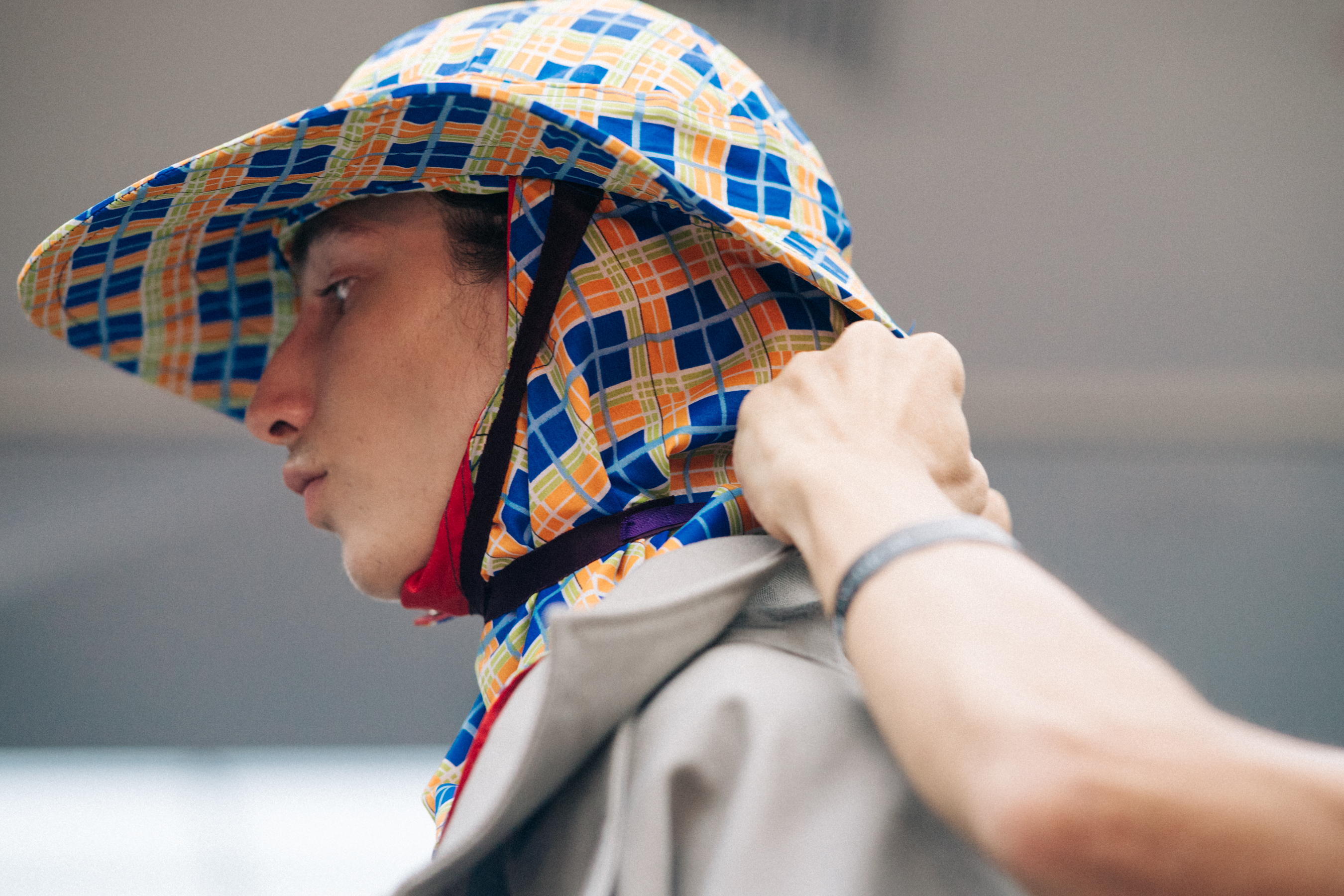 Male model getting hat put on