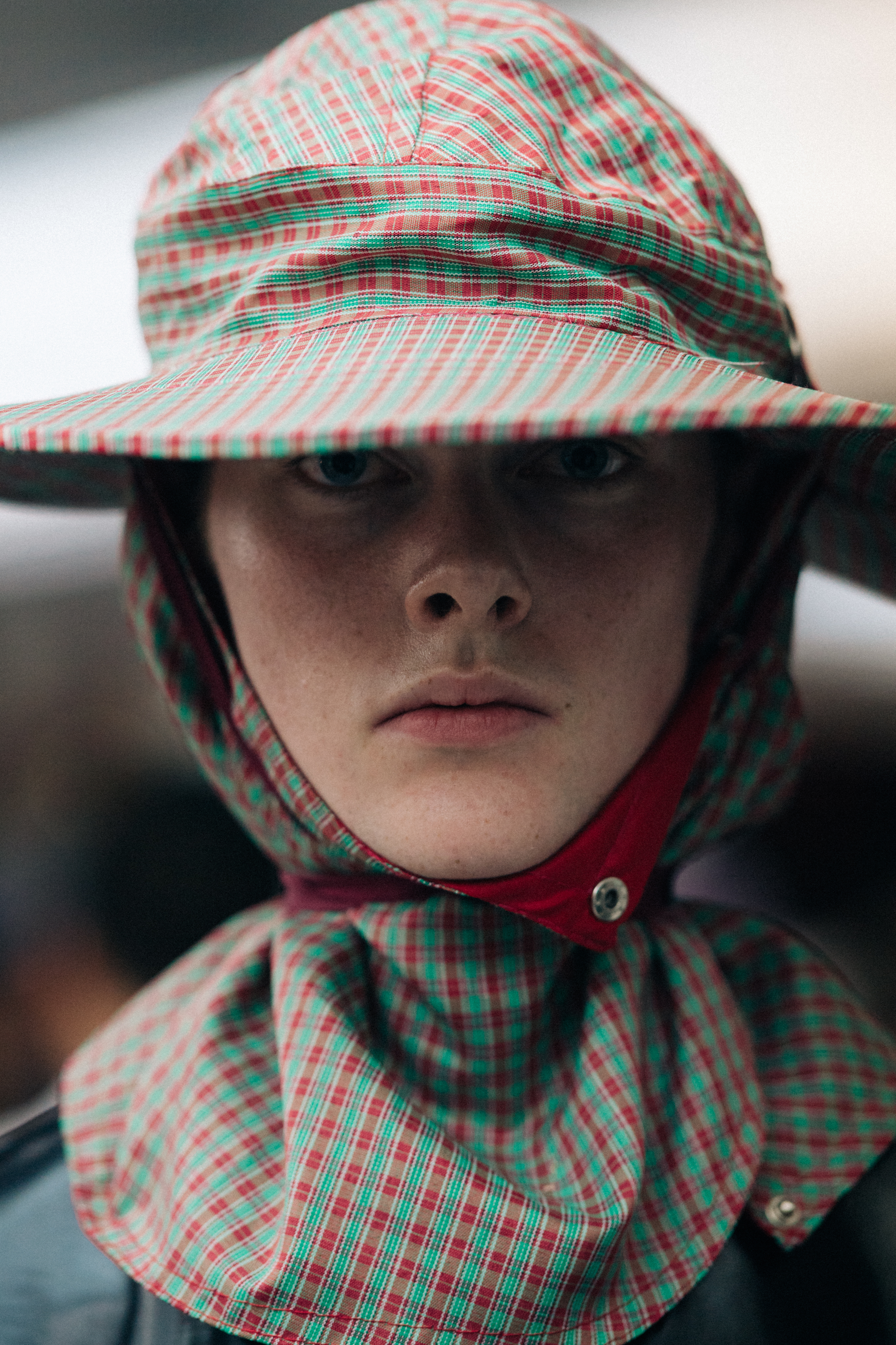 Model wearing red and green hat