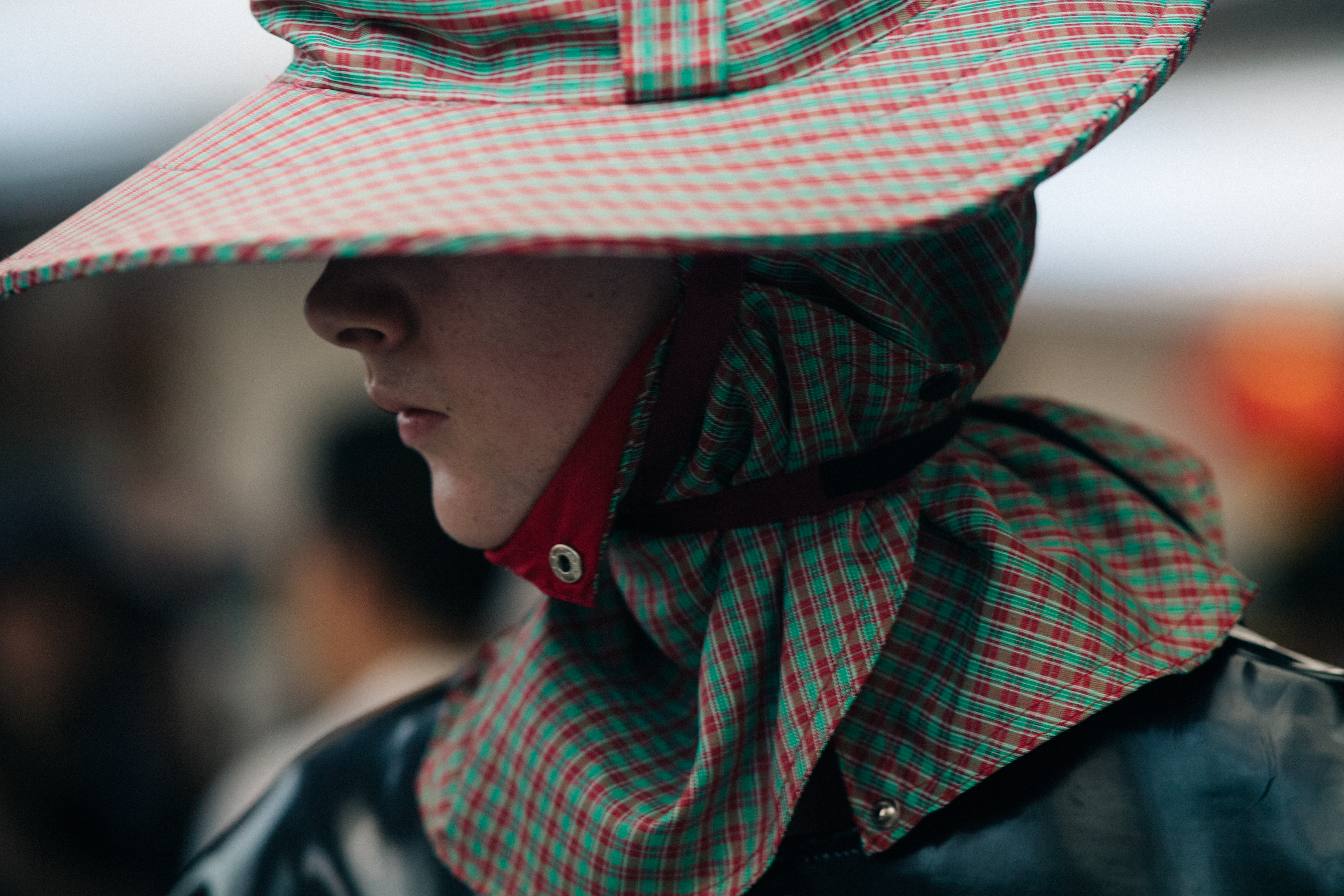 Model wearing red and green hat