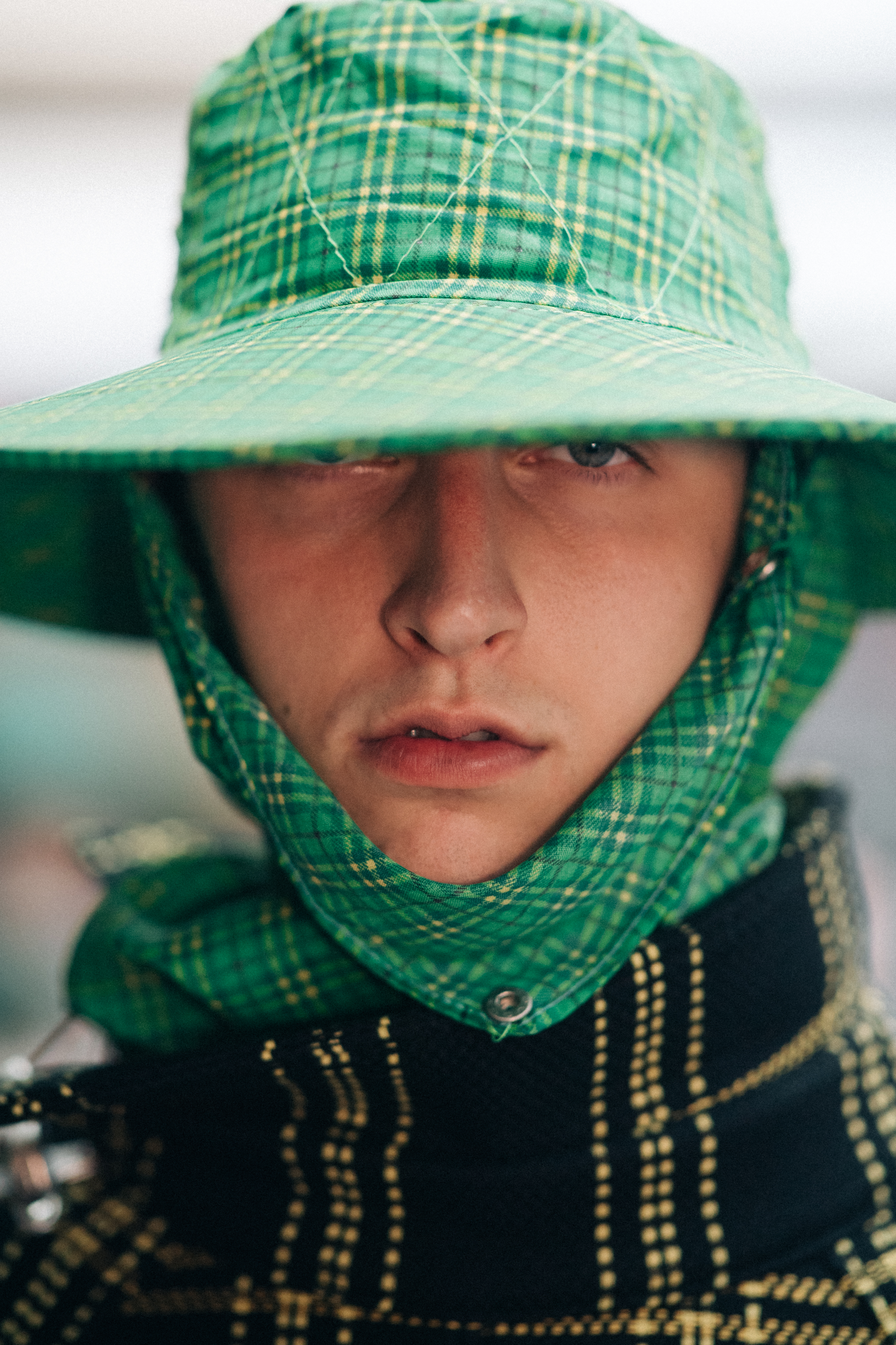 Male model wearing green rain hat