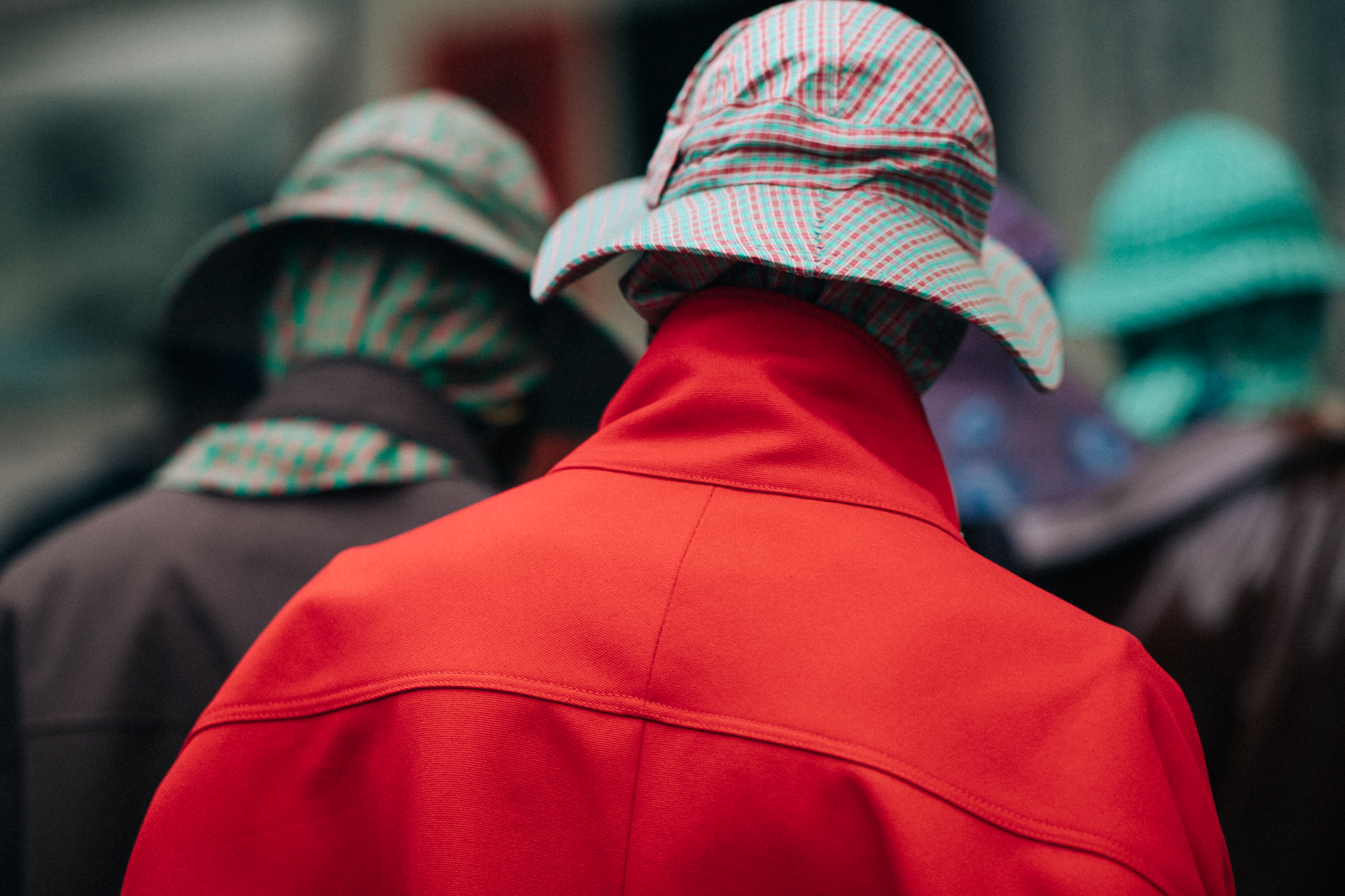 Two male models wearing rain hats