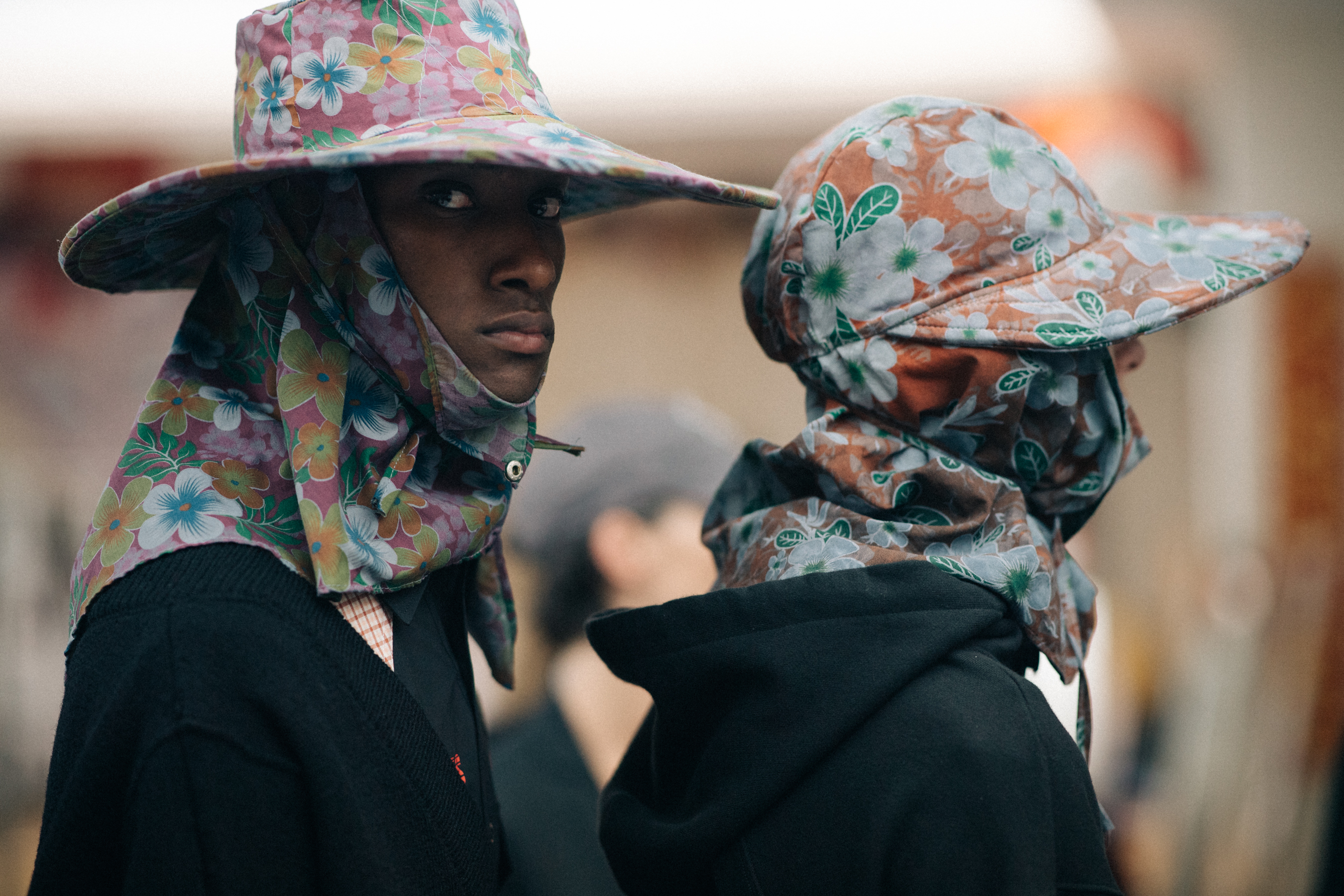 Male models wearing colorful rain hats