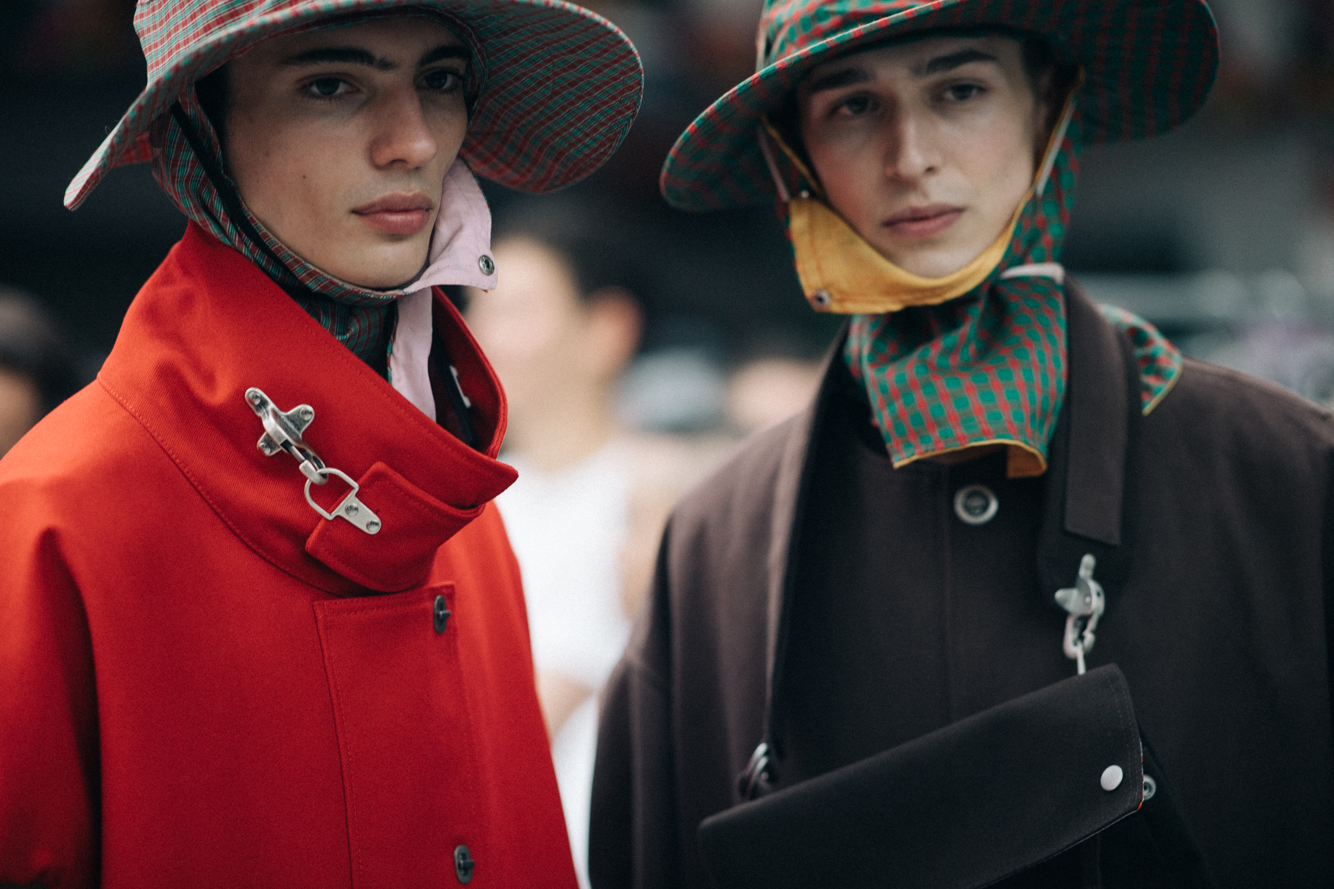 Male models wearing colorful rain hats