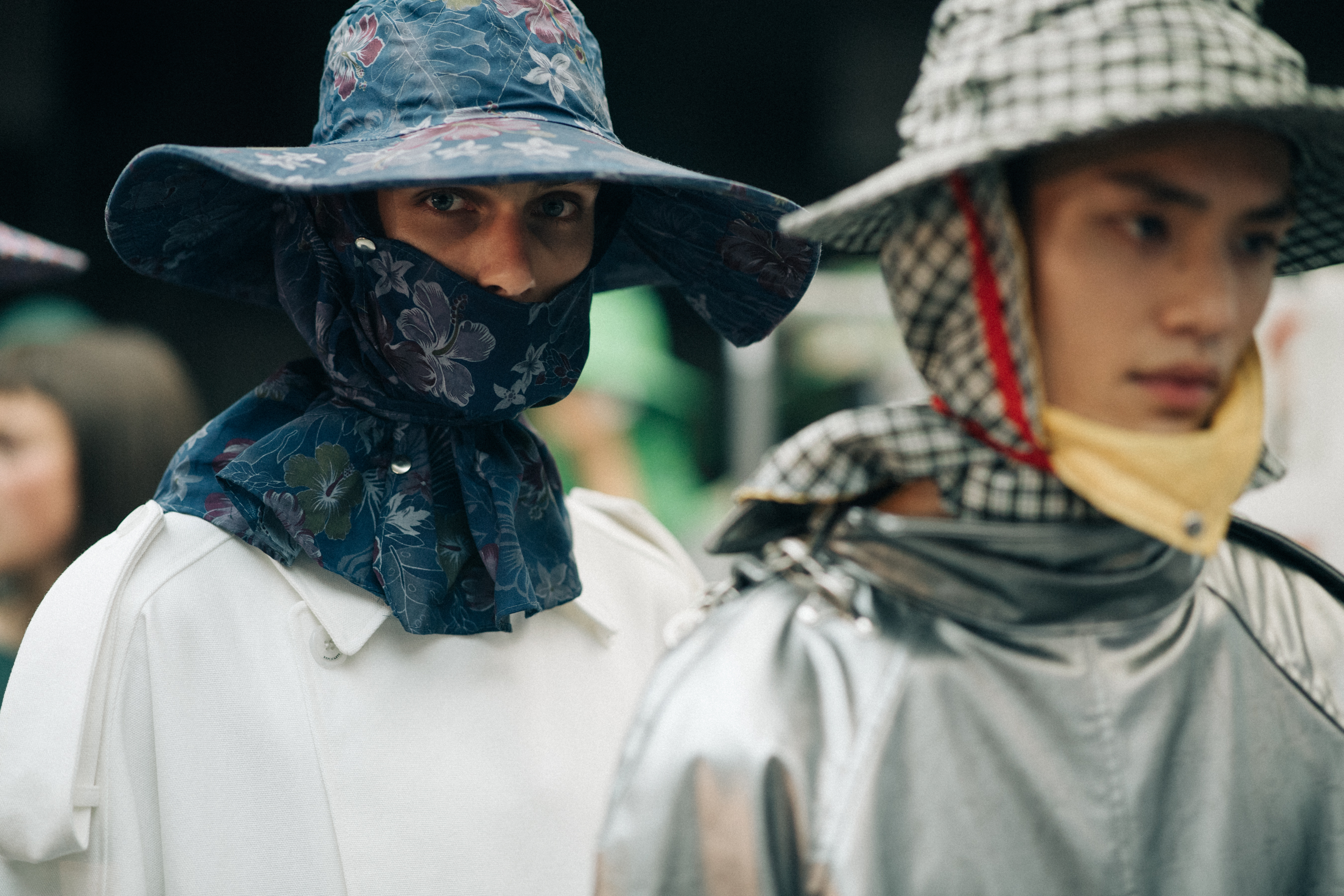 Male models wearing colorful rain hats