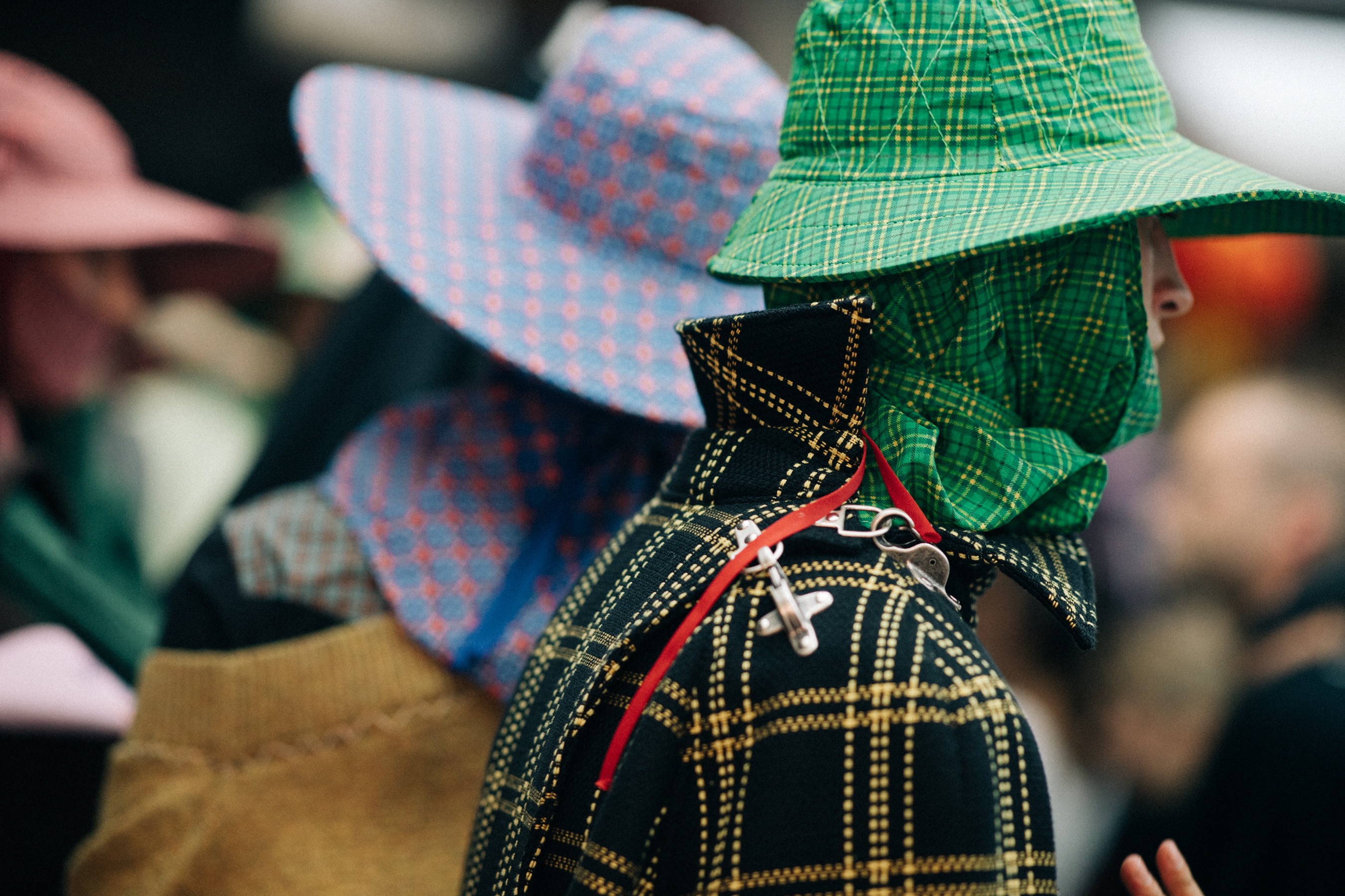 Male models wearing colorful rain hats