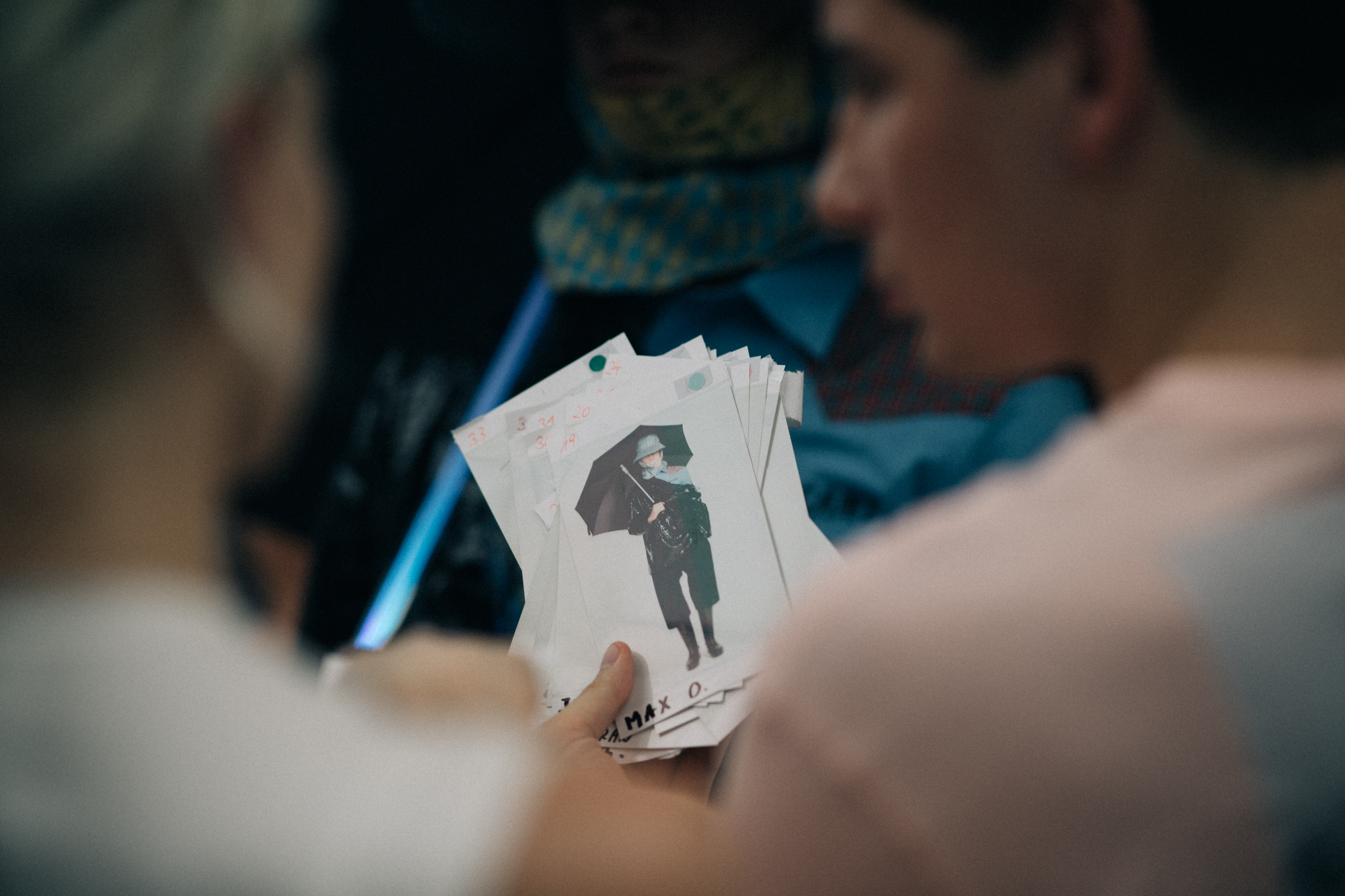 Staff holding polaroids in their hands