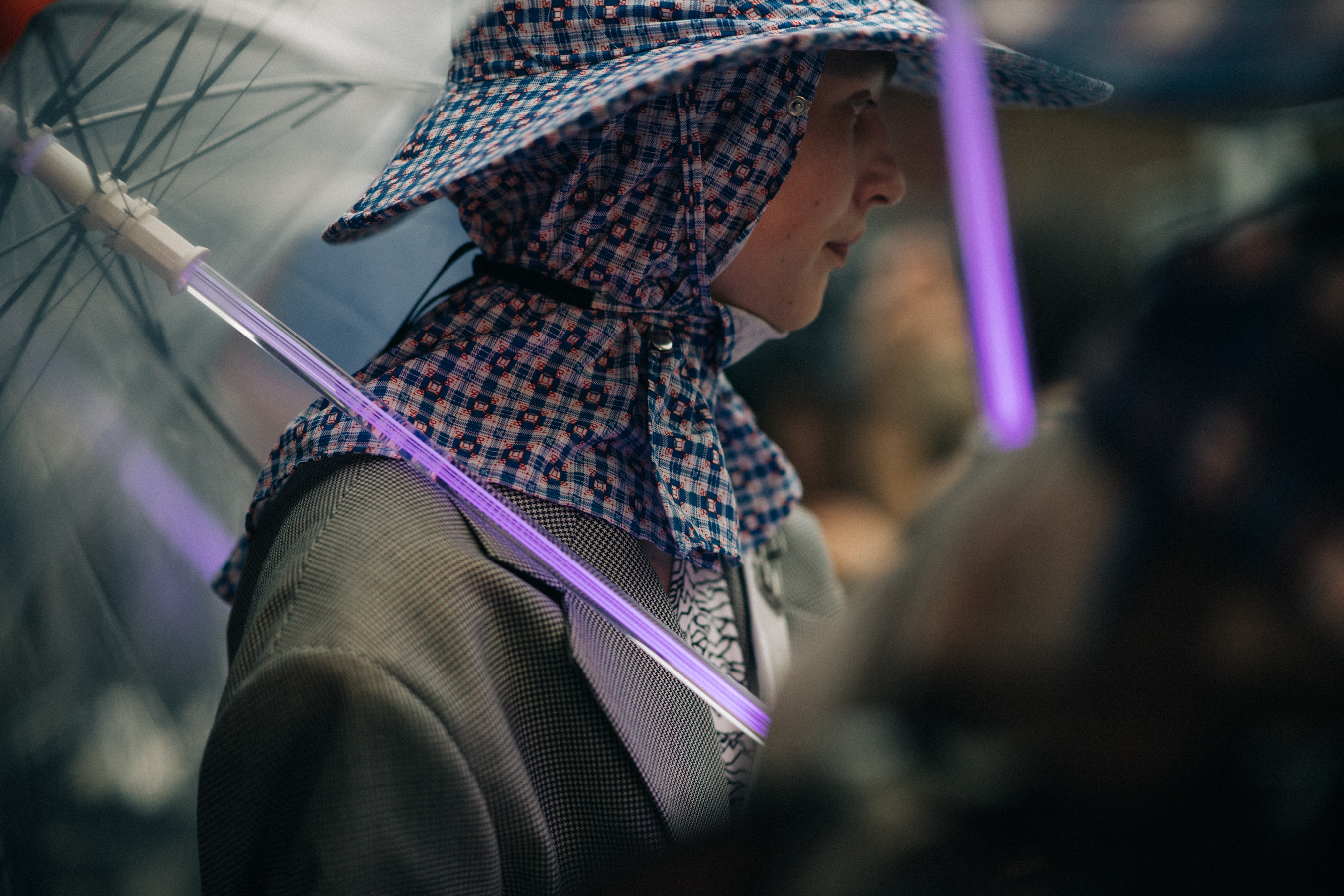 Male model wearing purple rain hat