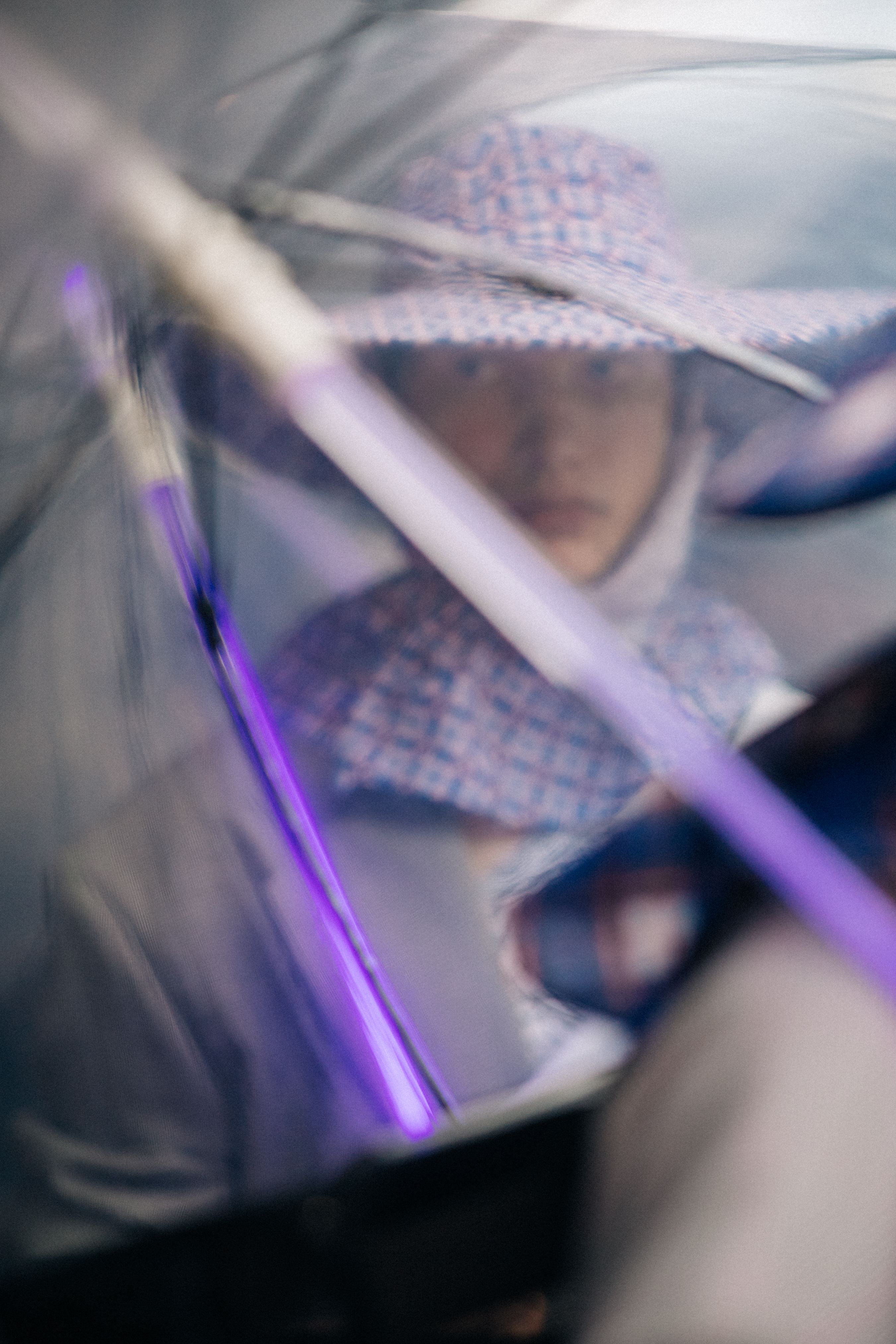 Male model wearing purple rain hat
