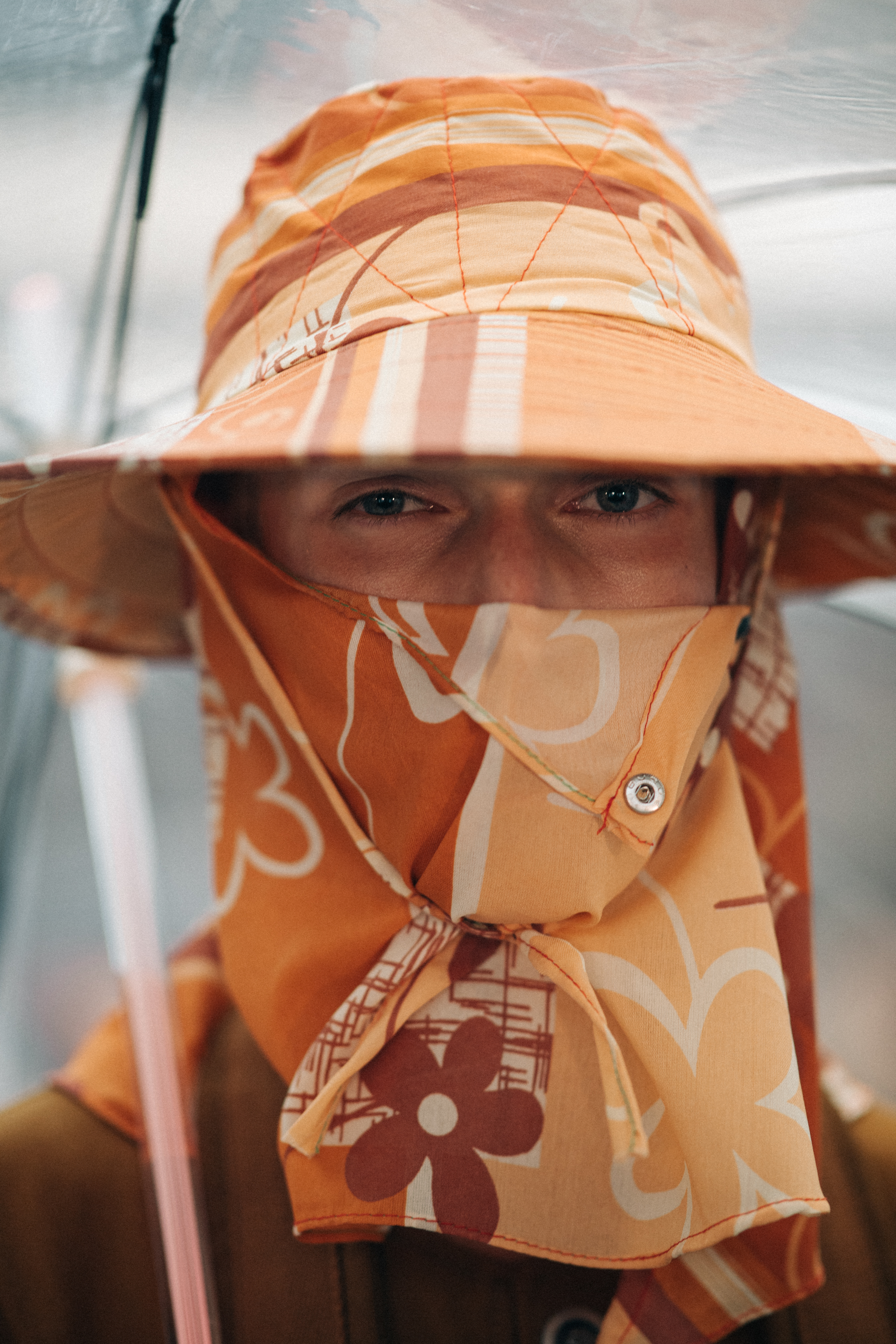 Male model wearing orange head piece