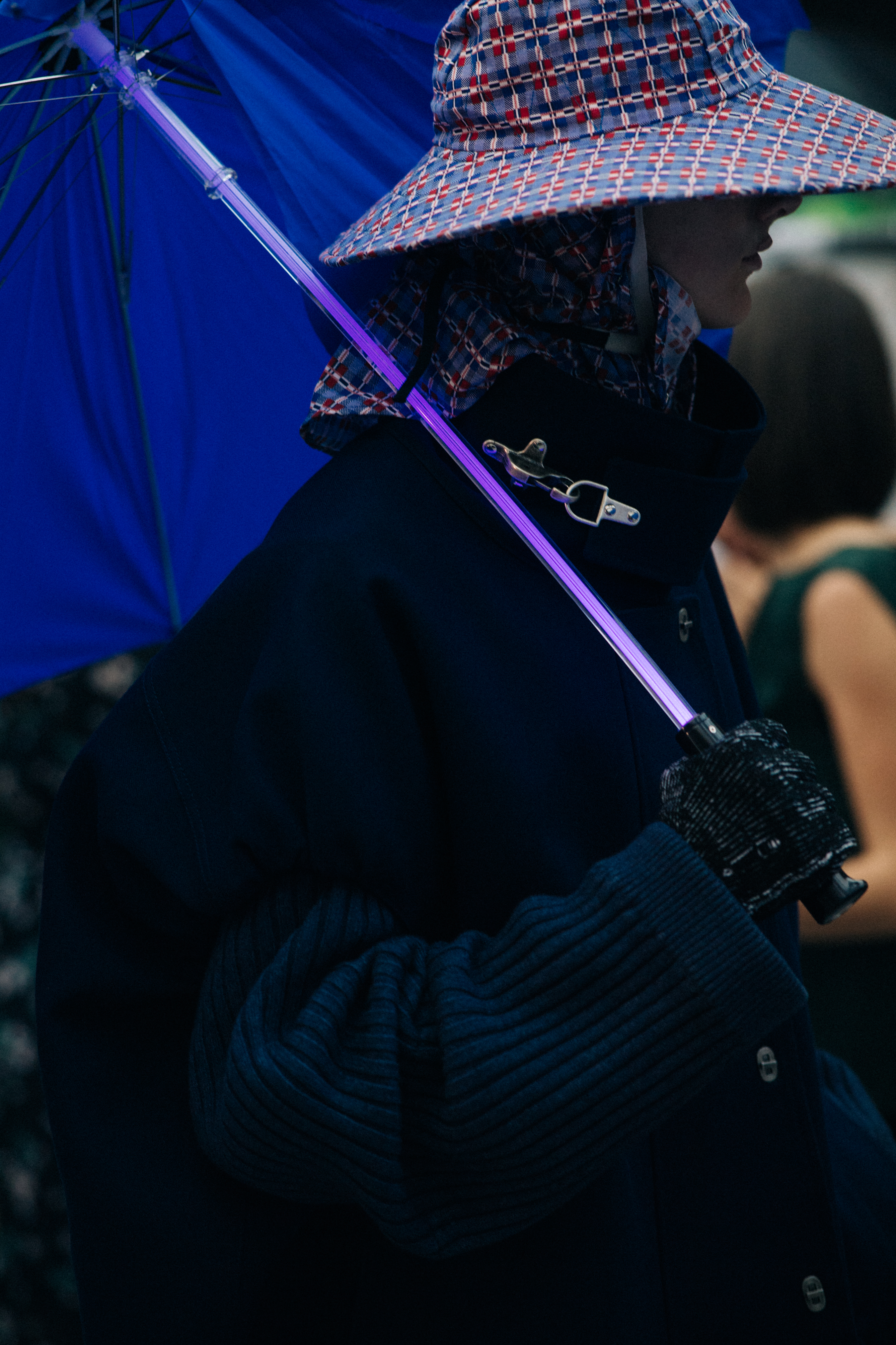 Male model with covered head wearing umbrella