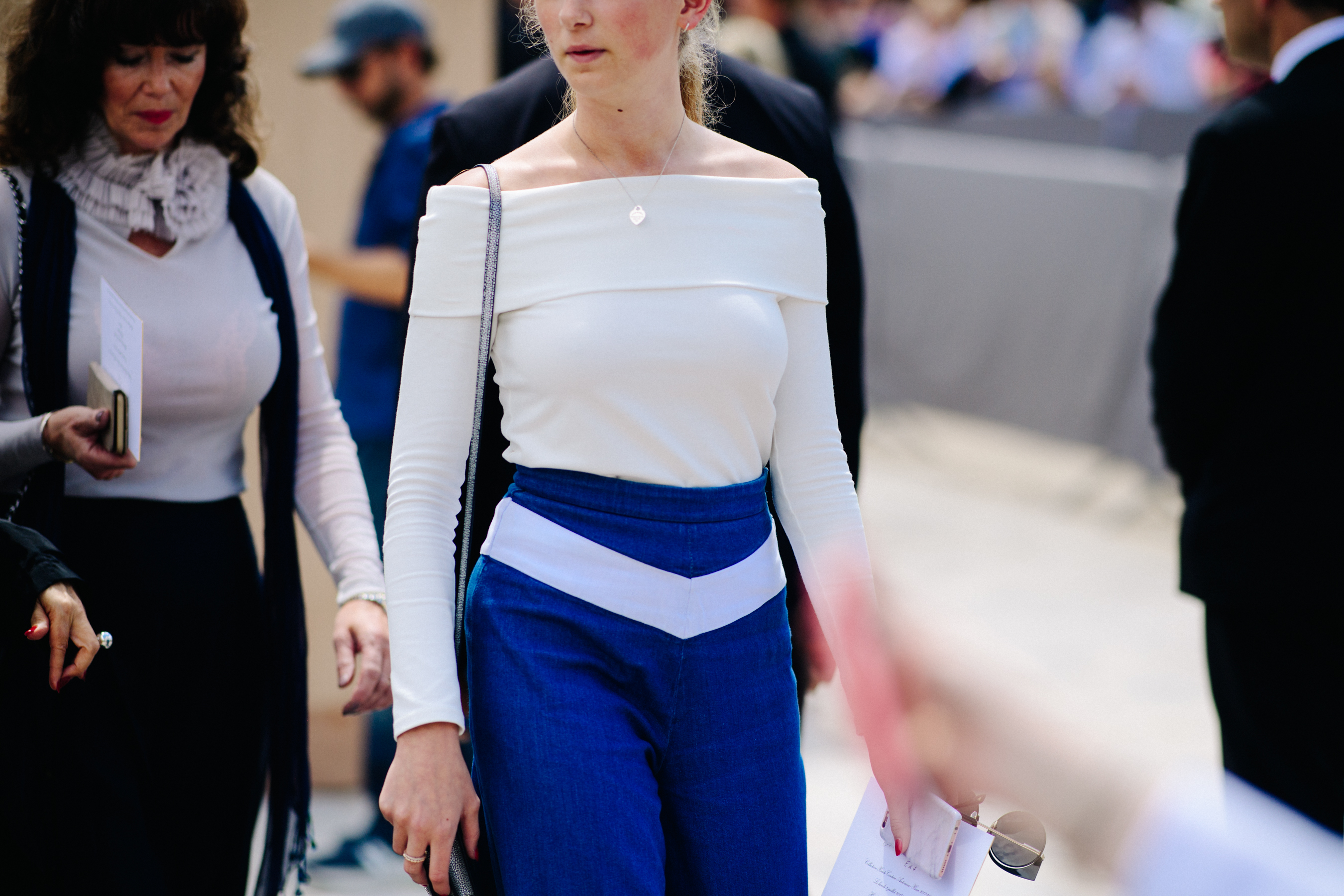 Woman wearing blue pants and white shirt