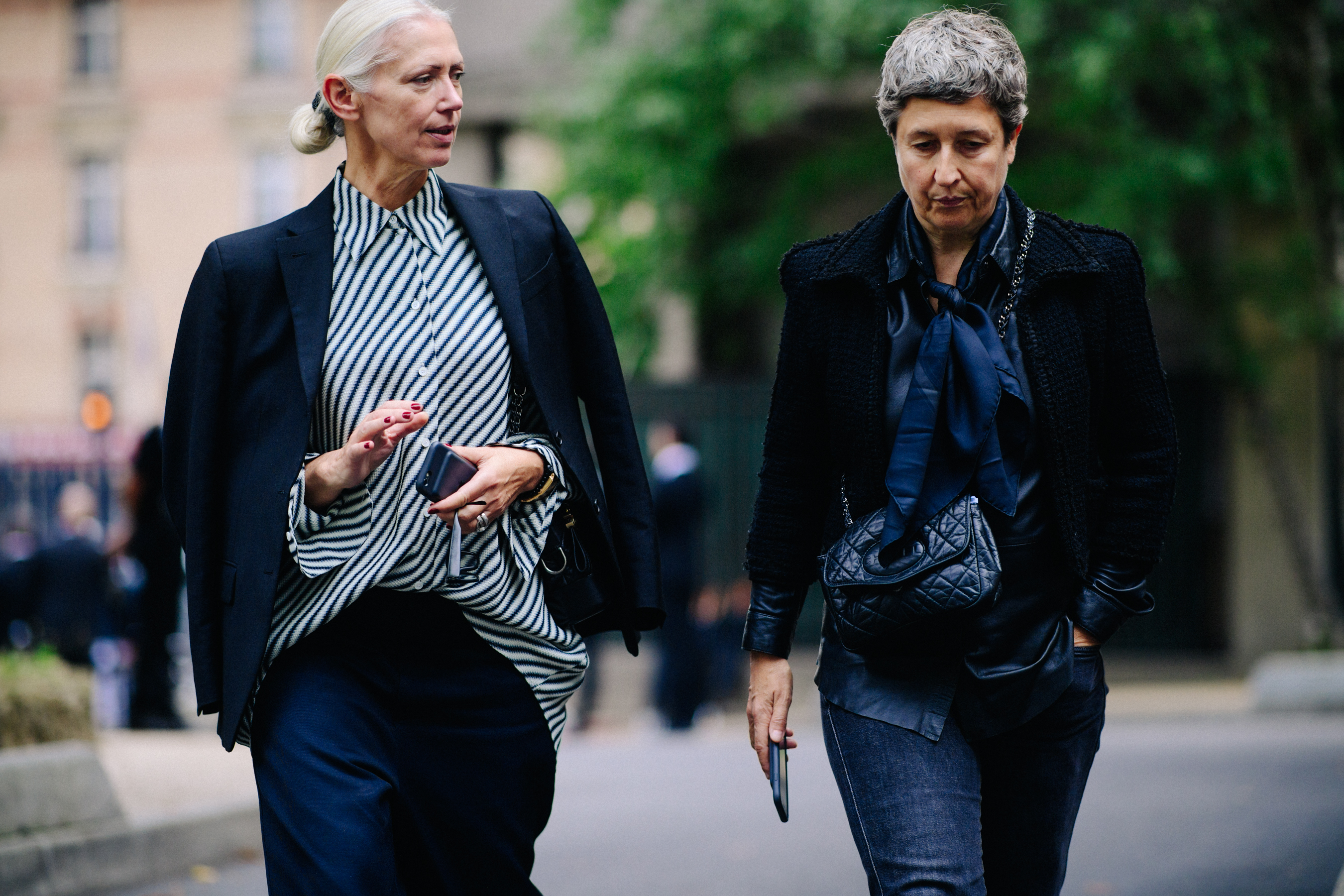Two women wearing blue outfits