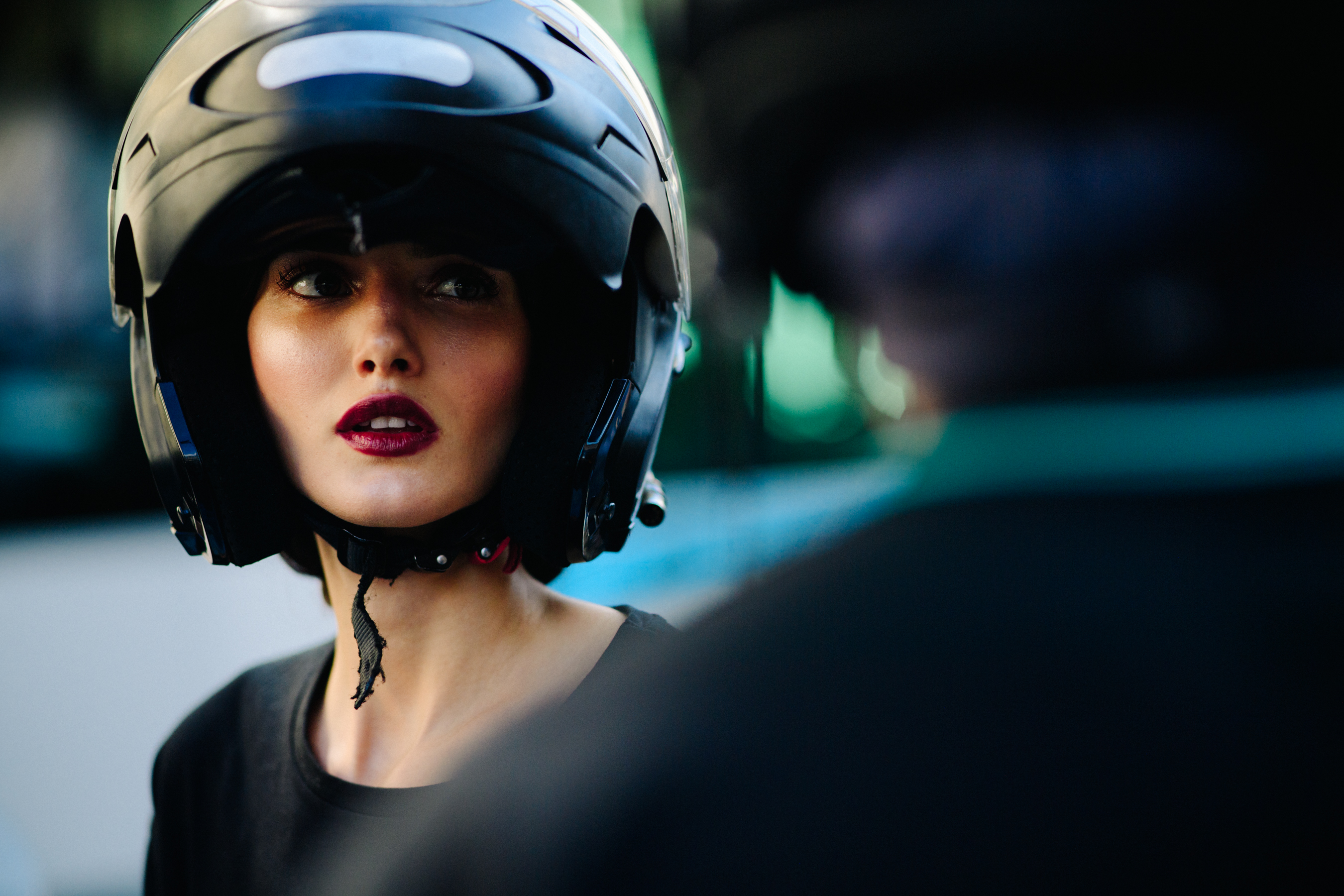 Model wearing scooter helmet after Ulyana Sergeenko