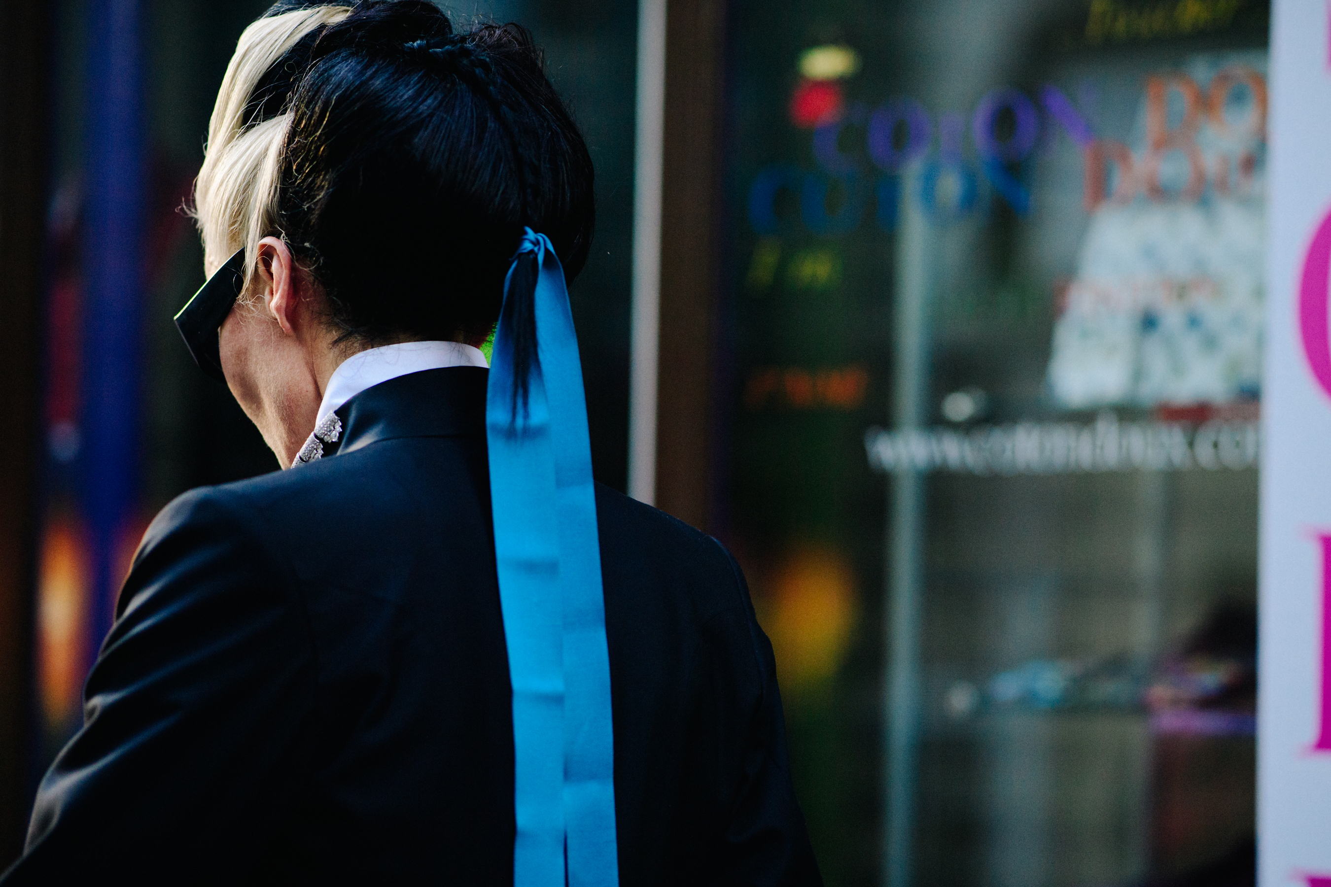 Fashion icon wearing a blue ribbon