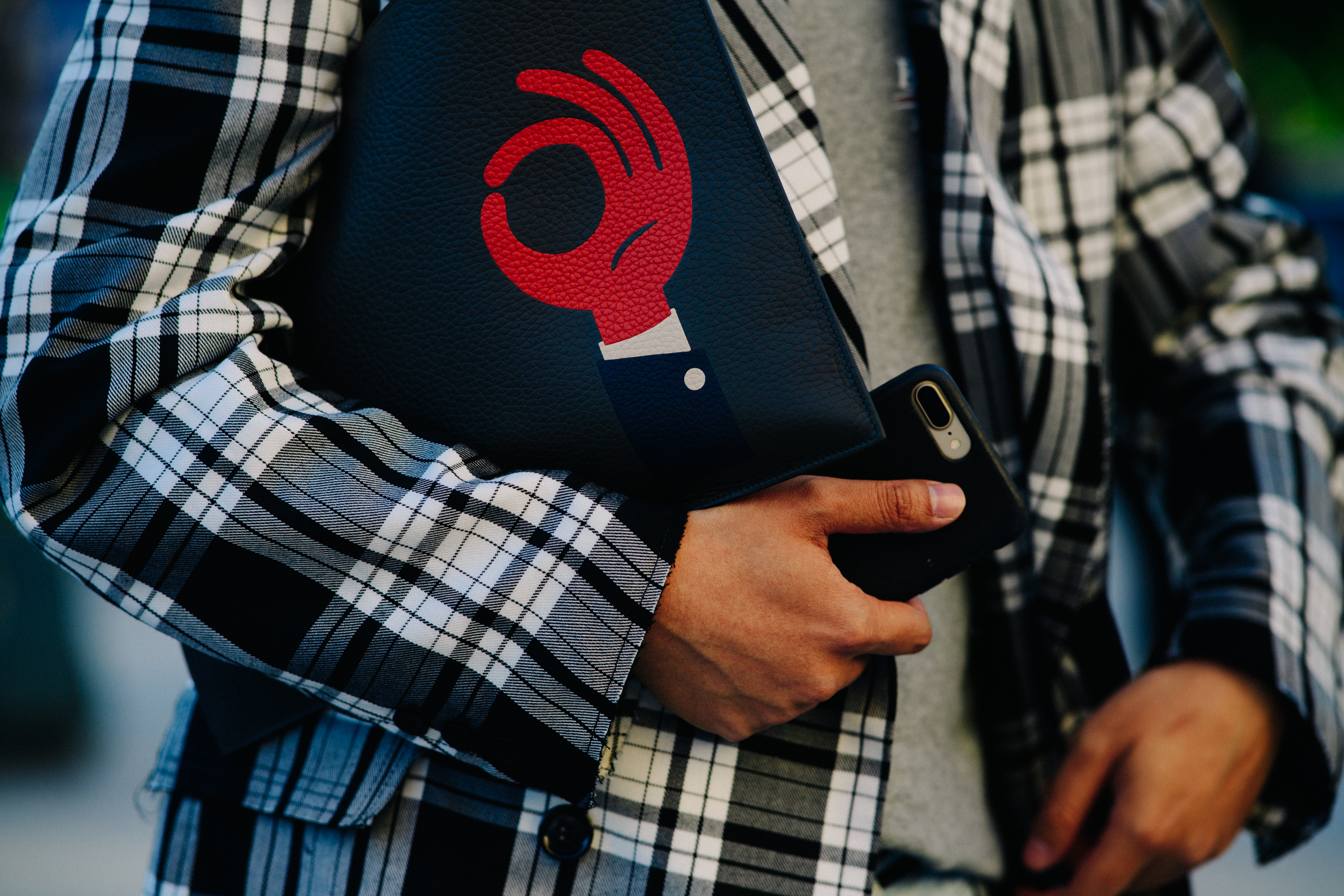Man wearing black clutch bag