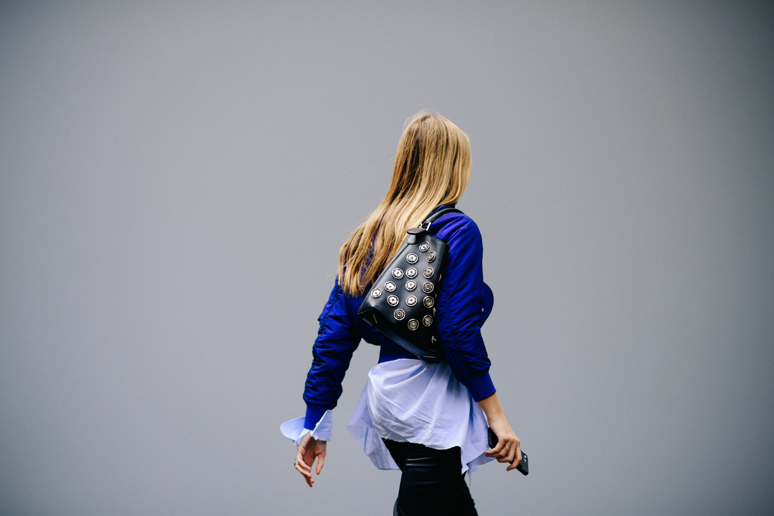 Jewellery designer wearing blue bomber