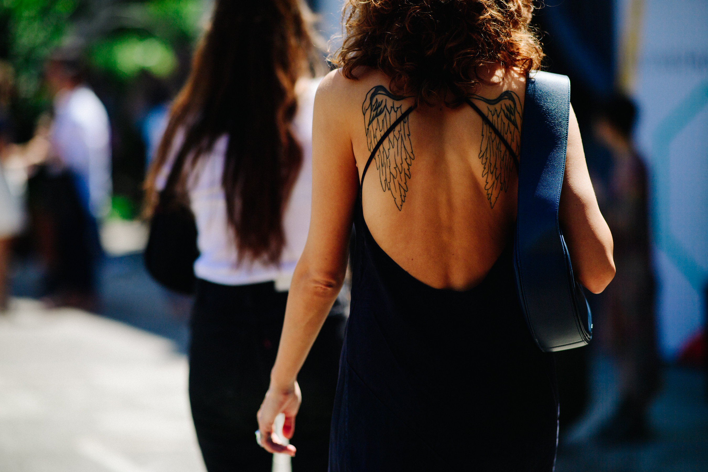 Woman with wings tattooed back