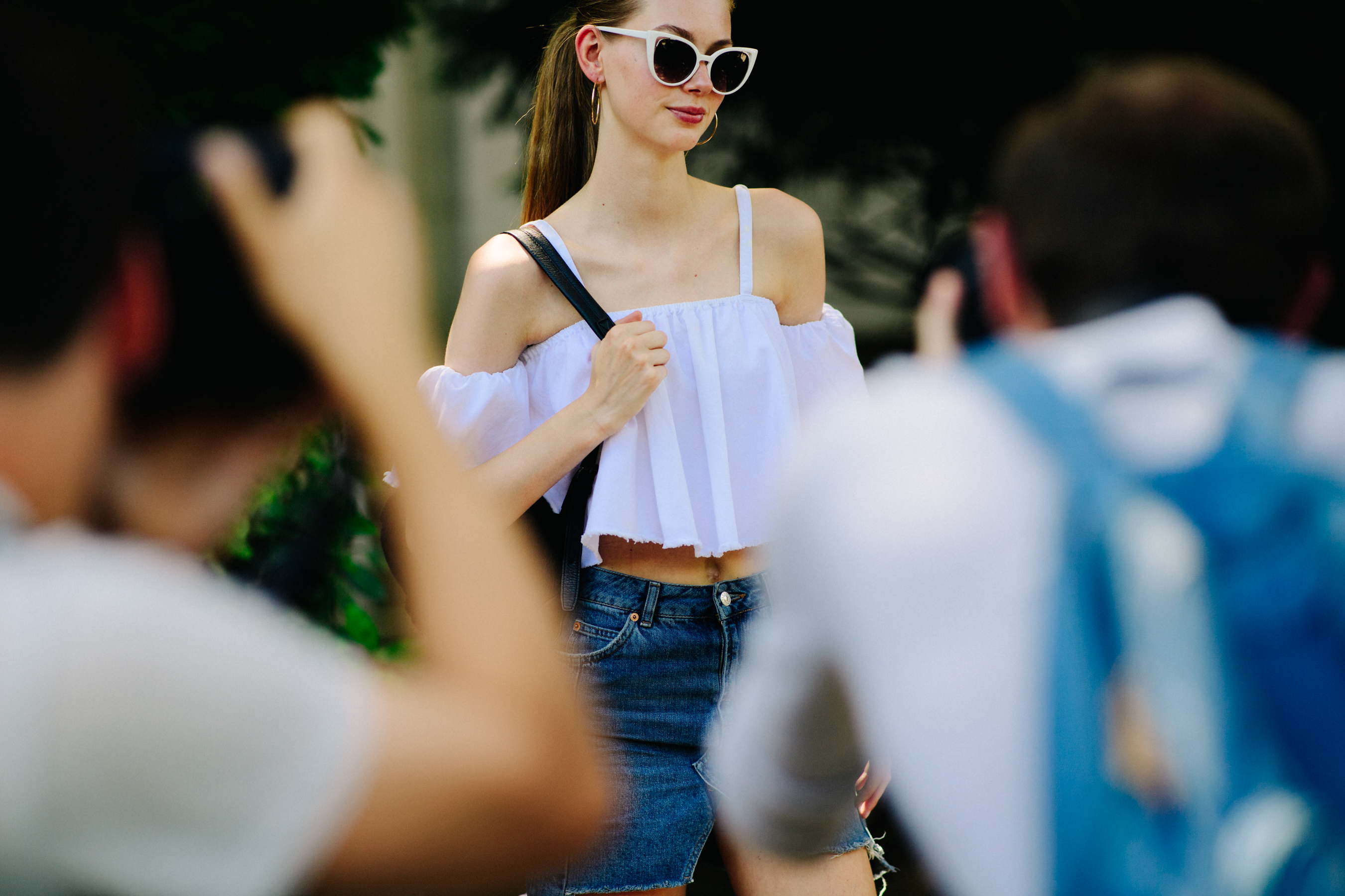 Model wearing white top and glasses