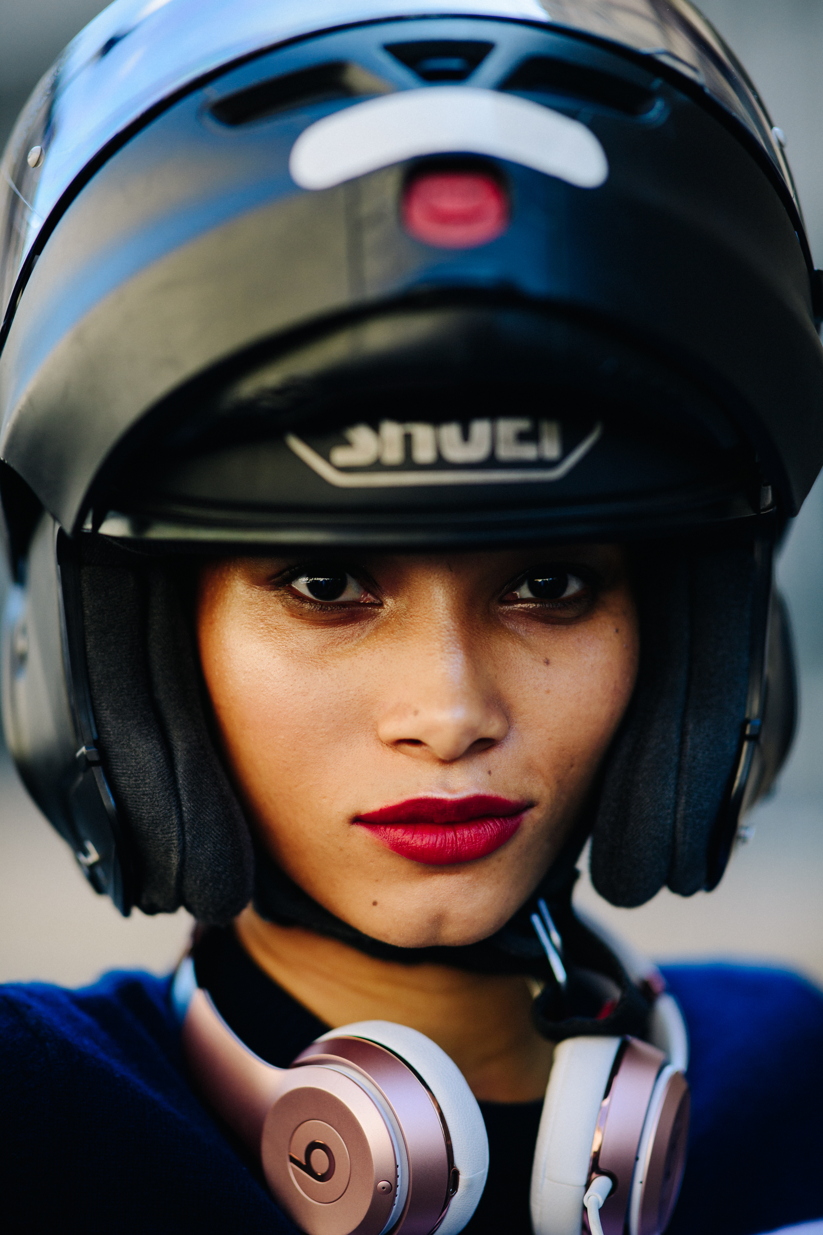 Model wearing scooter helmet after Ulyana Sergeenko