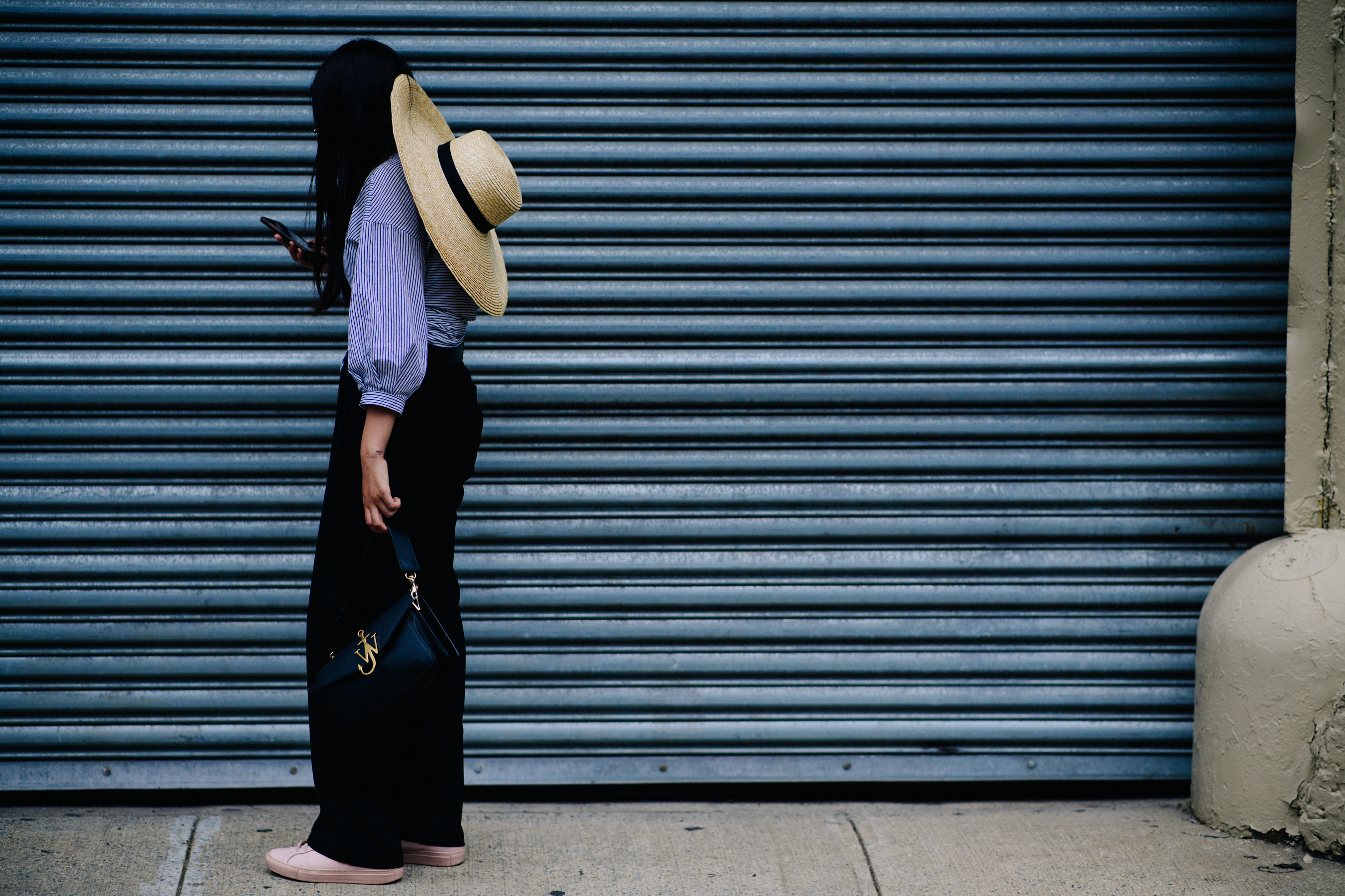 Woman wearing J.W.Anderson bag and hat