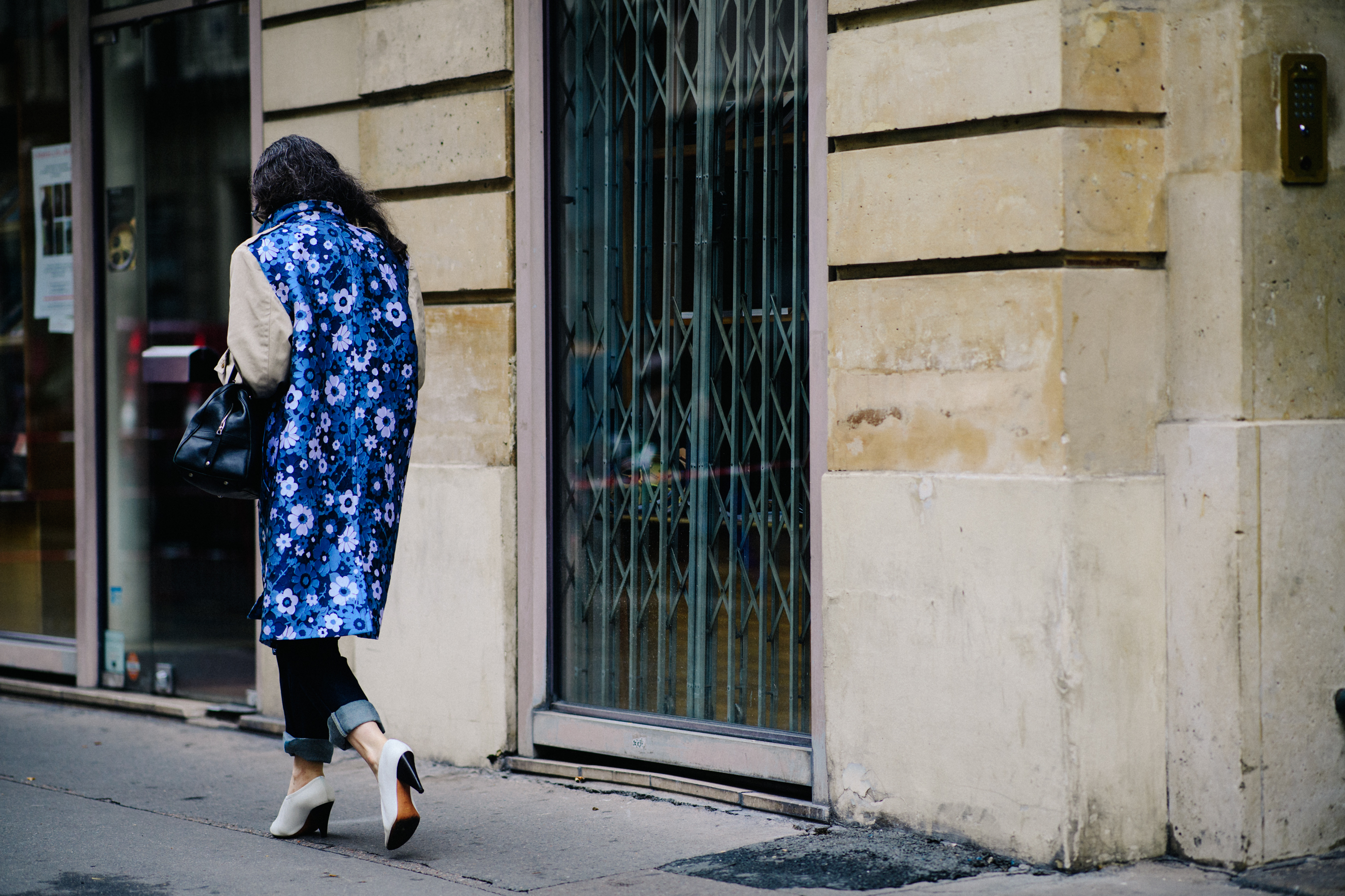 Woman wearing blue coat with flowers