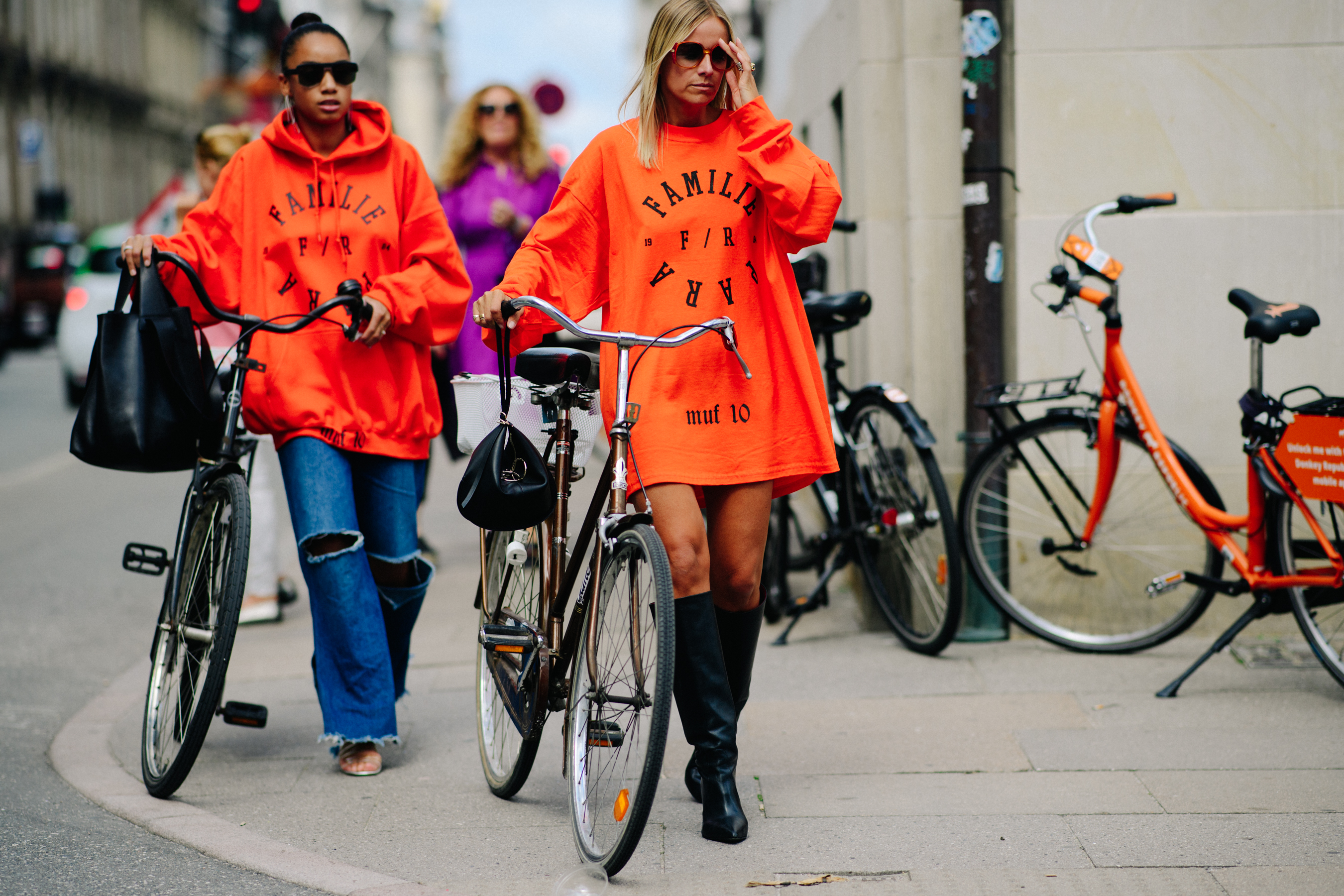 Two women wearing orange MUF10