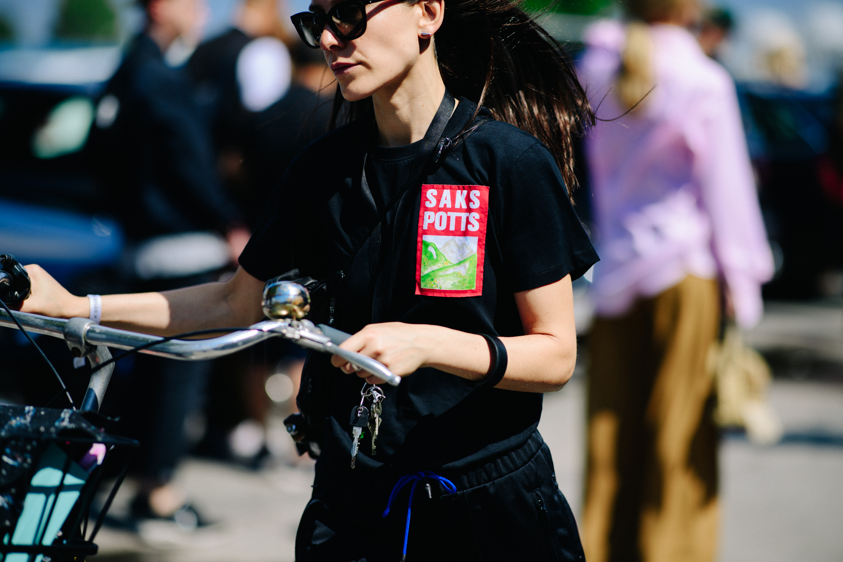 Woman with bike wearing sunglasses